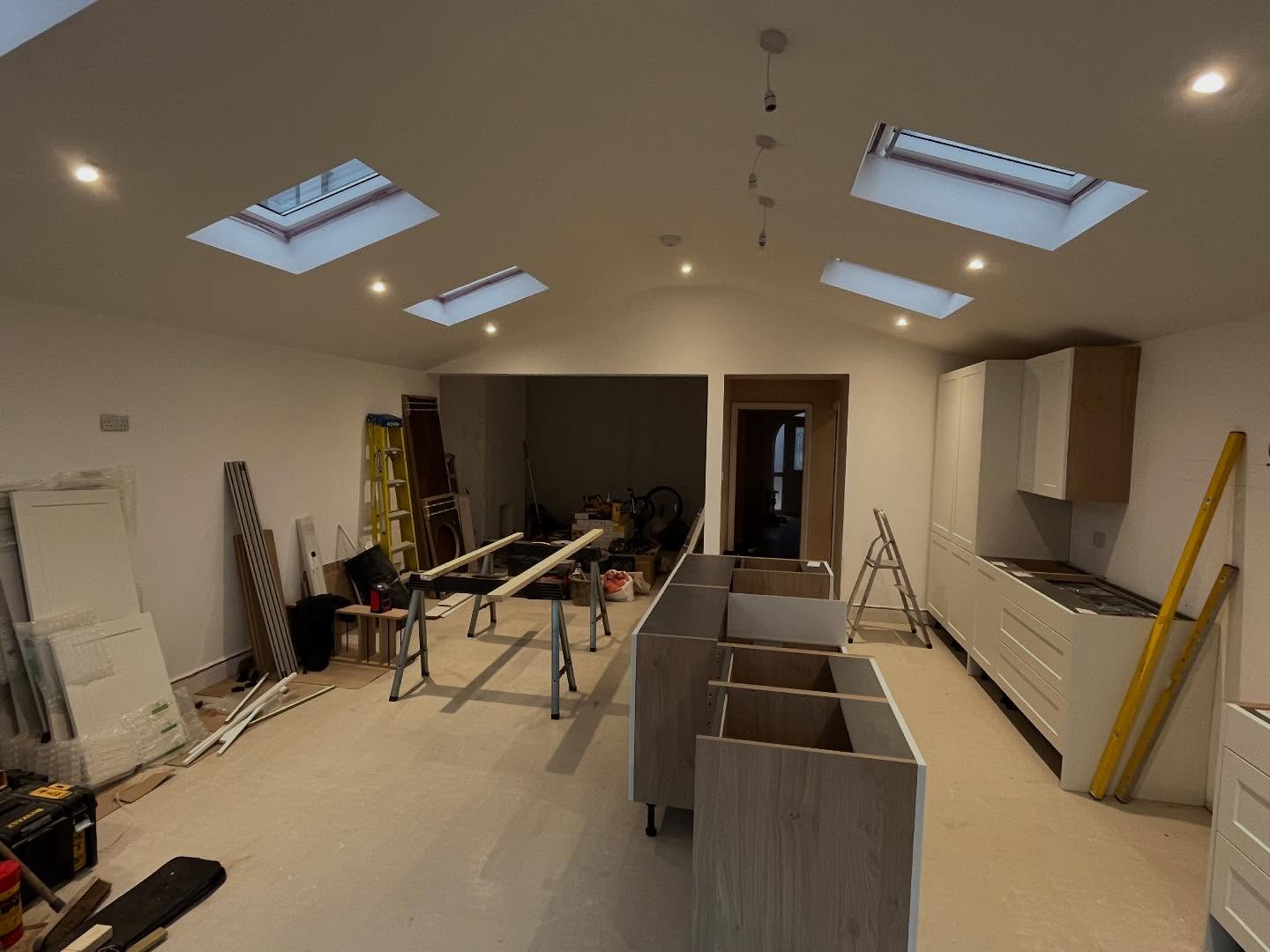 Update time! Extension is coming along nicely: kitchen installation is happening, underfloor heating and screed are finished, electrics are done, and windows and doors are in place #alderson #building #kitchen #carpenter #carpentry #electrics #electrian #window #doors #screed #heating #plaster #plastering #