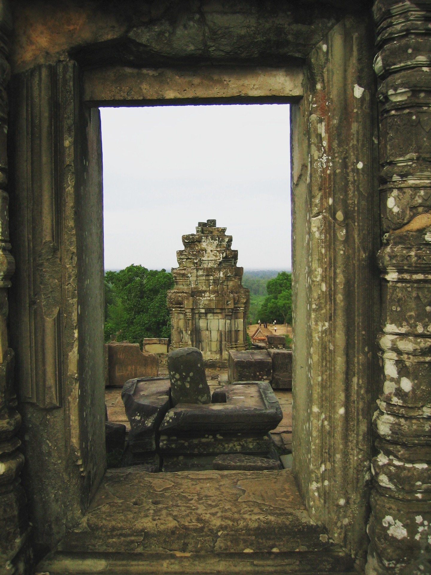Passage from Travels in the Land of Hunger: A backpacker's earthbound journey from the East to the West 🌏📖
Tuesday, May 20, 2004
Leonardo and the other driver took us to Prasat Trapeang Ropou. Many tourists and backpackers gathered at this site to hike and climb Phnom Bakheng, a Hindu and Buddhist temple built in the 9th century, to view the sunset from its peak. We followed the crowd to a ruined stone staircase to ascend a hill covered in thick tropical vegetation. At the top of the stairs and across a flat open plain stood the impressive walled pyramid temple ruin of Phnom Bakheng, composed of five levels. We walked across the plain peppered with stone ruins to the nearly vertical sandstone staircase that led up the eastern side of the temple. Once we had climbed the stairs, Robert and I took in the beauty of the thick, green canopy of tropical trees that expanded to the grey horizon in all directions. Hidden within this verdure were the monuments of Angkor’s long and once-lost civilization.
We waited for the sun to set, knowing the cloudy evening would prevent the best experience. Regardless, waiting at the top of this temple, crowned by five towers with so many people from around the world, was fascinating.
#TravelsInTheLandOfHunger #travelmemoir #memoirwriting #indieauthor #bookexcerpt #backpacking #backpackinglife #solotravelers #travelphotography #cambodia #cambodiatravel #adventuretravel #traveldiaries #siemreap #phnombakheng