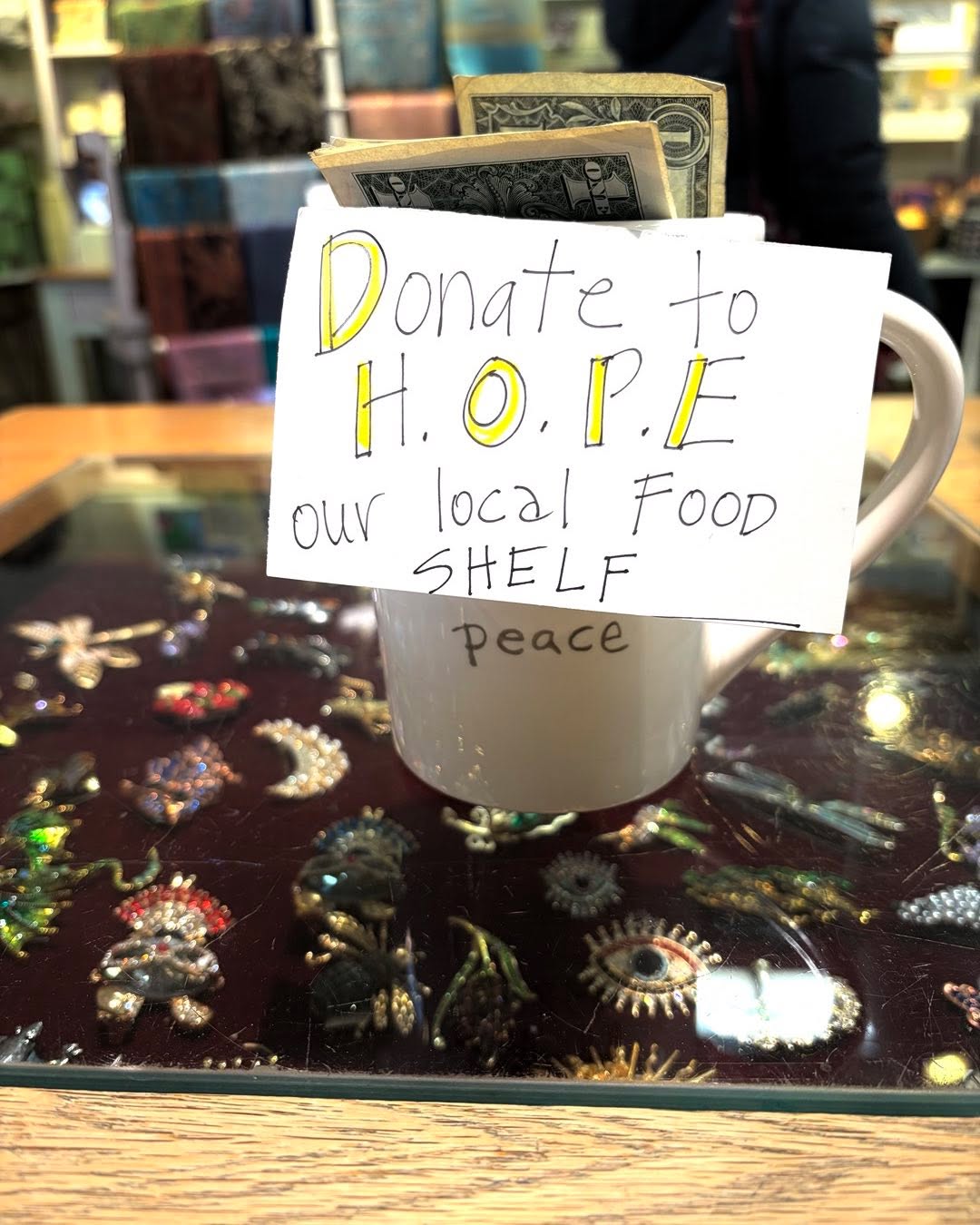 This little cup at our sales desk has collected $400 in 8 weeks for the local food shelf really kind of incredible. It takes a village. #smalltownlife #middleburygives #localfoodshelf #holidaylove #sharethewealth