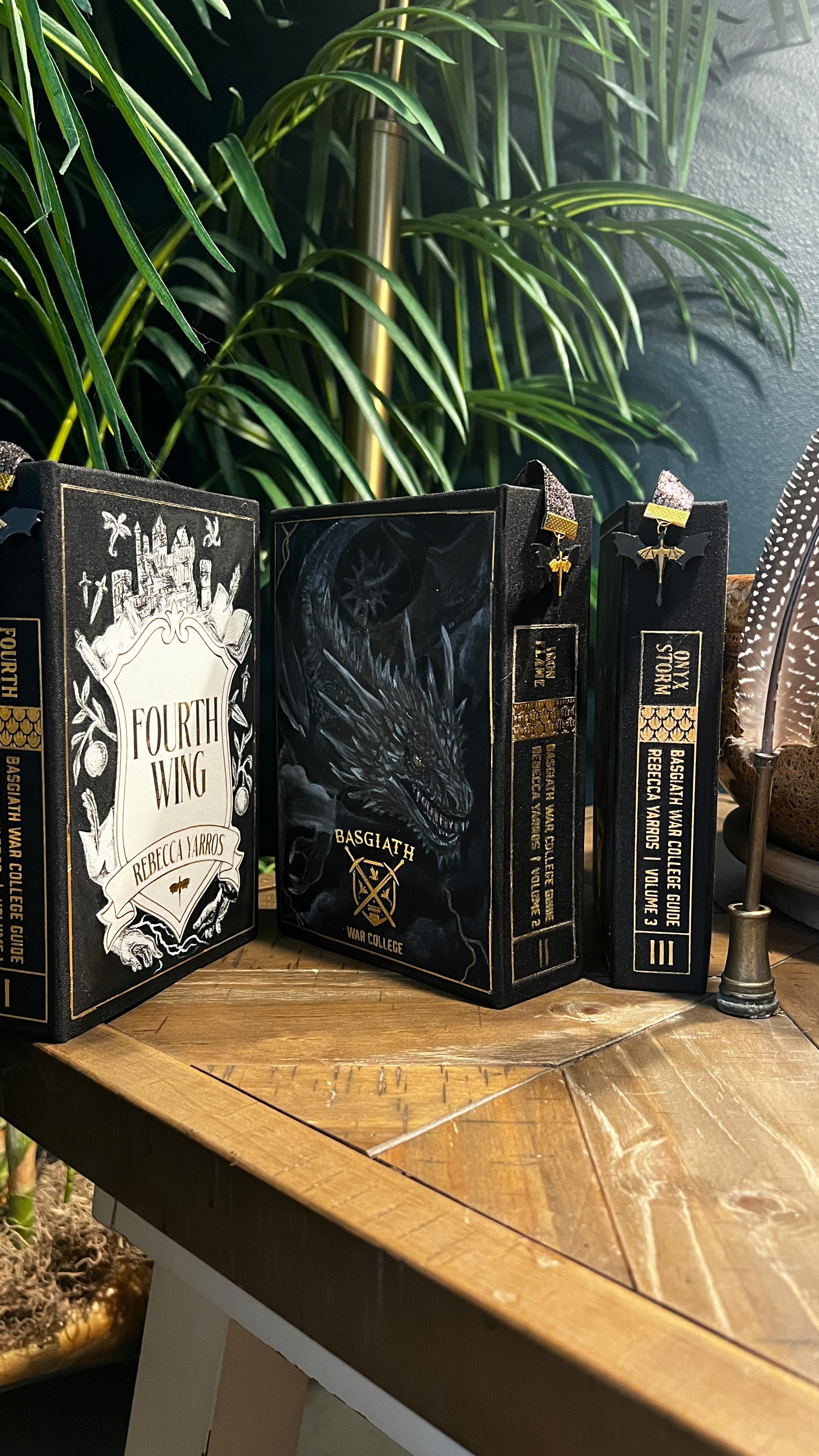 Only one more post about this project after this one, I SWEAR! A full rebinding of the Fourth Wing series so far, designed as a unified Basgiath war-college set. Each volume shares the same visual language of shielded covers, textbook spines, storm-charged endpapers and inscriptions. The illustrations, fore-edge painting, and dragon portraits evolve alongside Violet’s journey.
Built with gouache (which I hadn’t even used before 2025 and is now my favorite medium), custom-printed materials, hand-lettered gold lightning, and a lot of slow problem-solving. This project was about translating scale, motion, and consequence into physical books that feel like artifacts pulled straight from the world. Thanks for taking me on this journey @bill.slattery.50 and @_meganslattery_
#bookbinding #bookrebinding #bookart #romantasy #fourthwing @rebeccayarros
