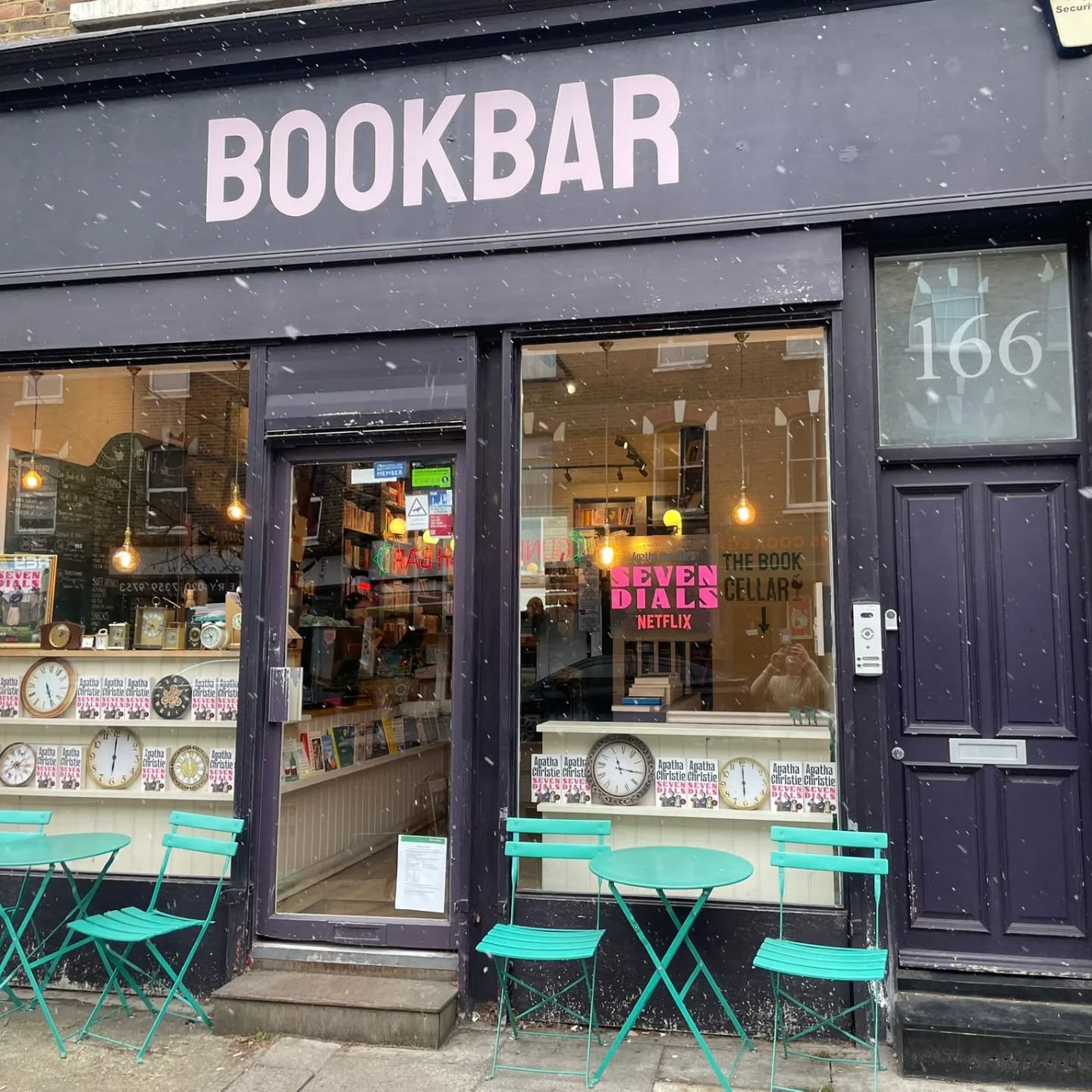 Starting the year with snow and a @netflixuk collab 🎥🎬📚
***UPDATE: 09/01 at 4:20pm: We have now officially run out of free goodie bags at both locations! Thank you so much to all who came by.***
We're thrilled to be celebrating the new Netflix adaptation of The Seven Dials Mystery alongside six other cracking indie bookshops, THE Helena Bonham Carter and Mia McKenna-Bruce and the Netflix team.
We've got this beautiful window installed at BookBar Islington, and both our Islington and Chelsea shops are giving out FREE Netflix tote bags, a notebook and copy of Christie's original novel The Seven Dials Mystery all week (or until bags and books run out!).
Those picking up their copy from BookBar Islington will get the chance to win tickets to the premiere of the first episode next week*. We have one set to give away in one goodie bag!
Come on down to BookBar and ask at the till to pick up your bag, notebook and copy while stocks last!
*Please check all the Ts&C's for the winning tickets - the premiere is in London and travel and accommodation are not included.