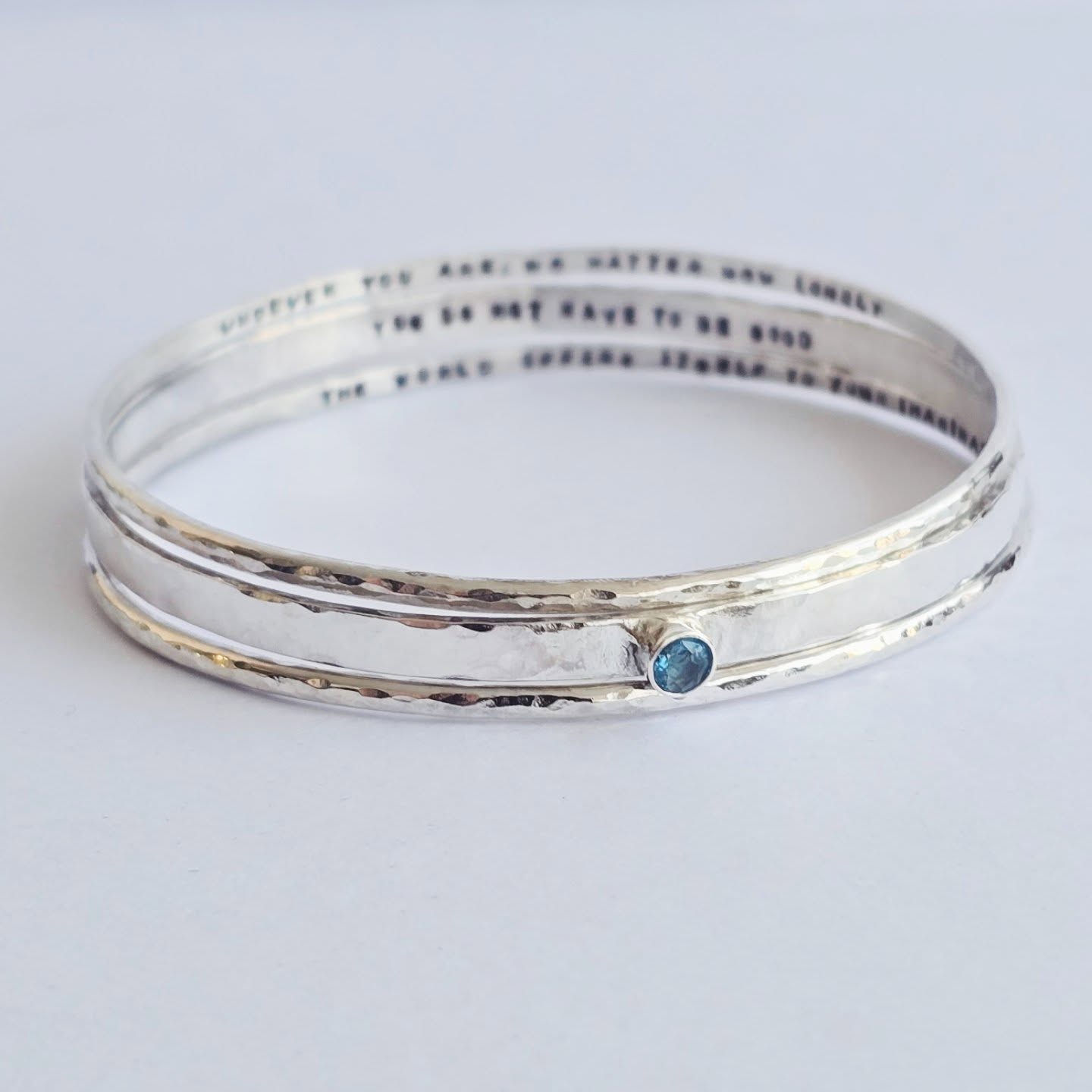 I really enjoyed making this set of 3 personalised bangles. Each bangle had a secret message inside and the larger bangle had a birthstone. Each letter is handstamped by myself with metal stamps and a hammer. 💎