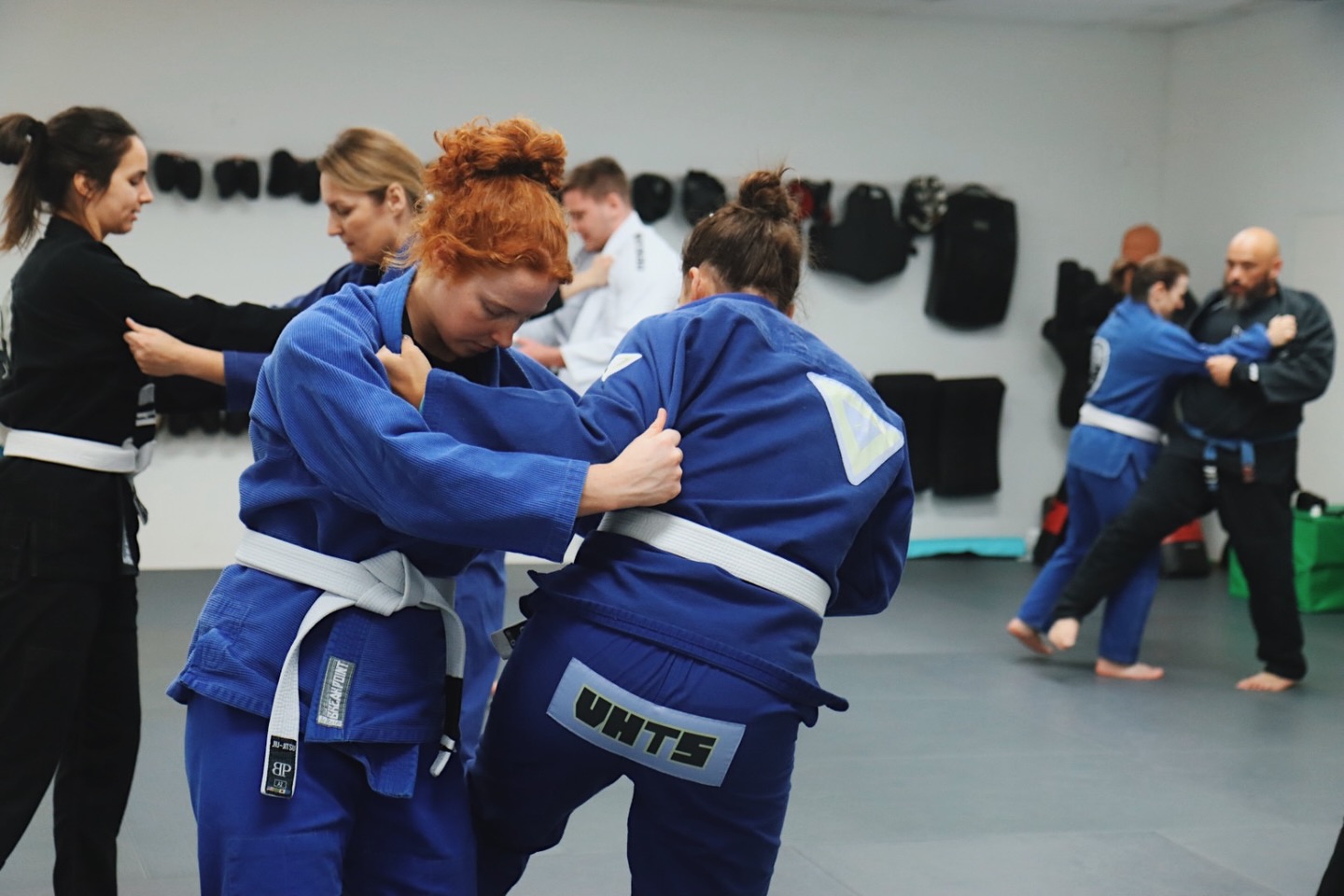 Get comfortable with standing up, even when it feels awkward. Learning grips, movement, and patience before the takedown. One detail at a time.