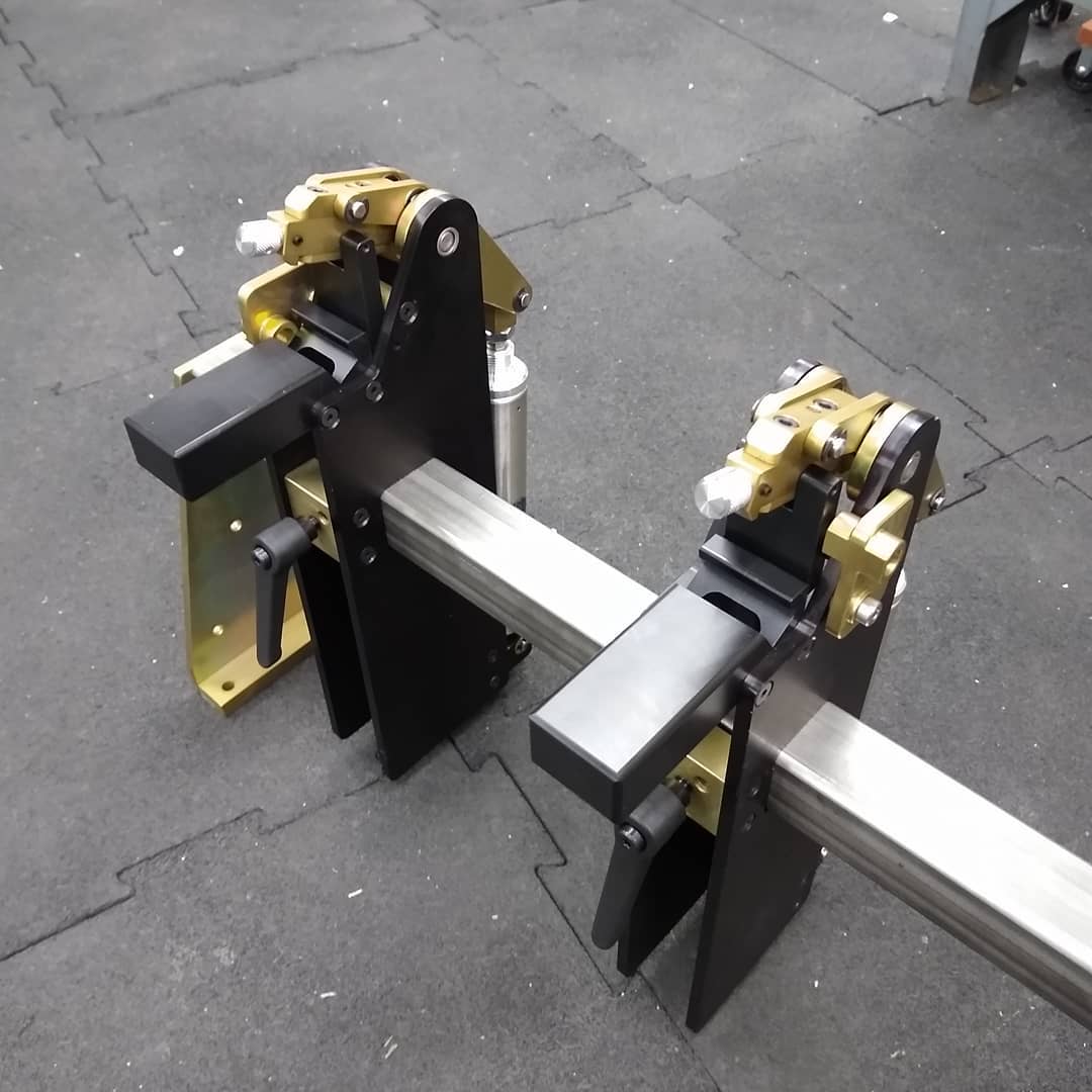 A bunch of them go on a rail the max length of the extrusion and are placed at predetermined intervals. Activated with a foot pedal.