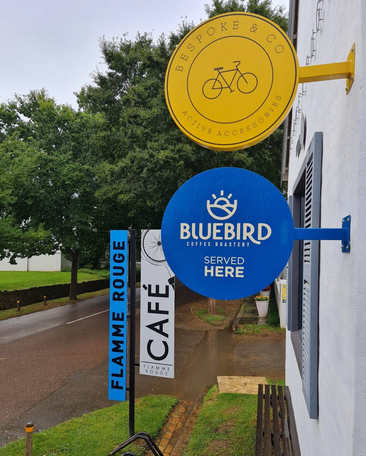 Eyecatching Cantilever lollypop signs. #bespoke.and.co #flammerougecyclecafe #bluebirdcoffeeroastery #lollypopsign #signco_howick