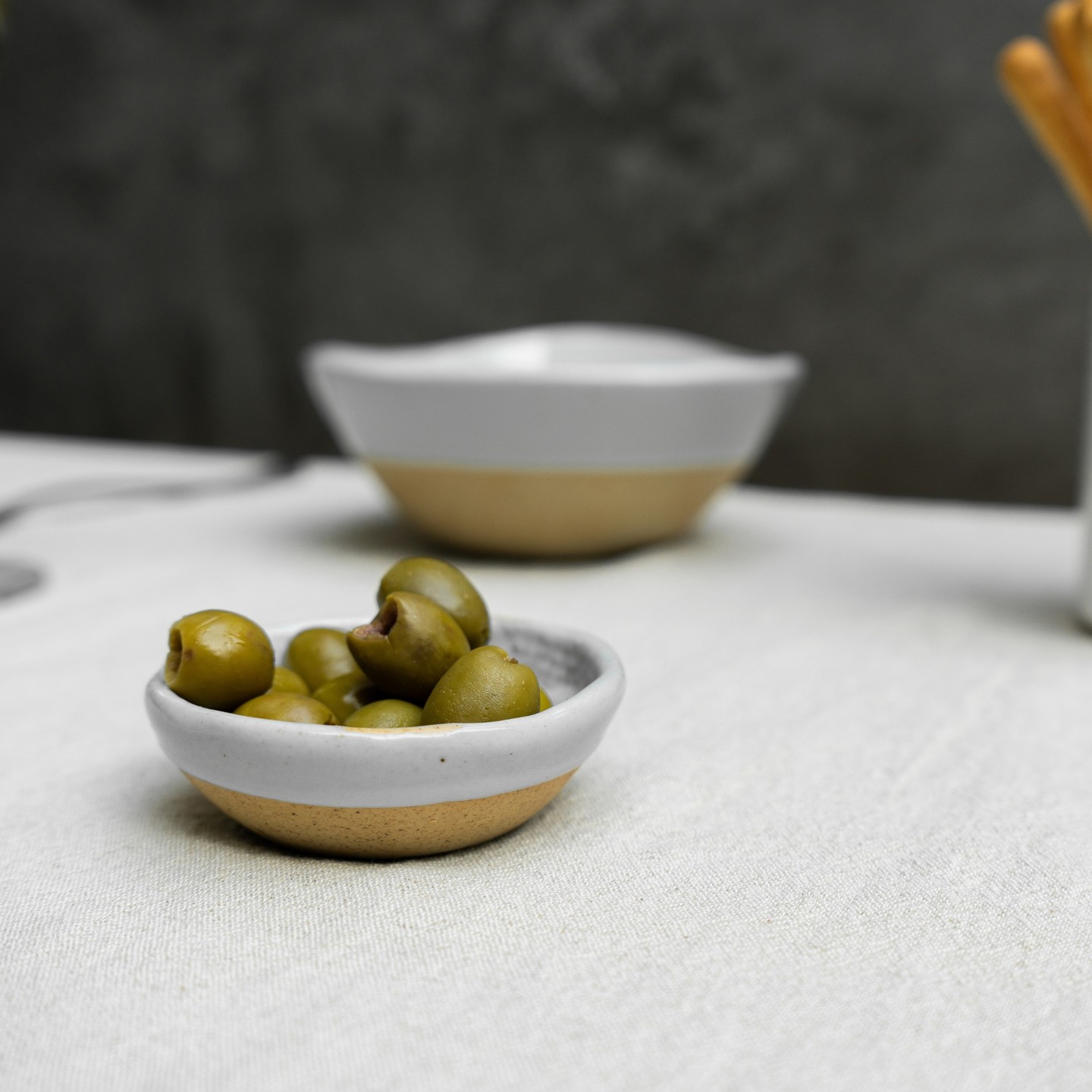 Get up close and personal with our dipping sauce dish from Craftstone! A multi-purpose dinnerware piece to hold your favourite condiments, sauces or just to hold a small portion of olives! Set your table with Craftstone, this tableware piece perfectly compliments the asymmetric bowls, featuring an organic shape and the iconic Craftstone half glaze exterior.
#dipdish #tableware #ceramicbowl #porcelain #dinnerware #craftstone #ceramictableware #donbellini #saucebowl #moderntableware #tablesetting #kitchenware #interior #designer #homeware #hkshop