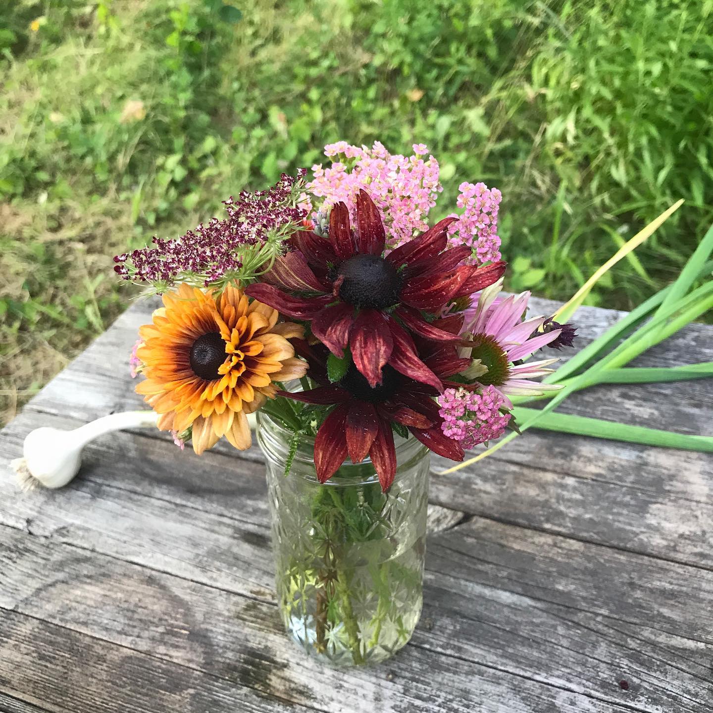 I always enjoy cobbling together a tiny bouquet from whatever is growing in the garden. Wild plants and edibles often make it into the mix.