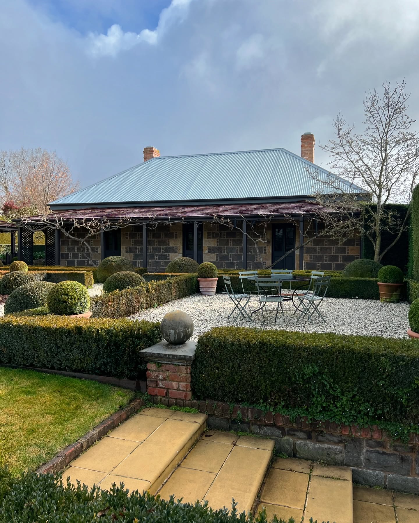Mid winter and the Old Rectory garden is hibernating: the perennials and the wisteria have been cut back and the beds mulched. Inside however the hydronic heating ensures a warm stay, the @bose speakers throughout can play your favourite playlist, there’s plenty of books and magazines to read in the library, cards, backgammon, CD and DVD players if there’s nothing to watch on (two) TVs. Or of course the wonderful @botanikkyneton is just across the road!
Whether you’re in the region to visit local vineyards, attend a wedding of just taking a city break, the Old Rectory is a unique and luxurious option.
Booking enquiries via our website or @airbnb
The Old Rectory is listed by @nationaltrustvic and is rated ⭐️⭐️⭐️⭐️⭐️ on @google and AirBNB.
@visitmacedonranges
@daylesfordmacedonranges
@macedonrangeswine
#kyneton
#kynetonaccommodation
#macedonrangesweddingaccommodation
#heritageaccommodation
#kynetonluxury
#topiarytuesday
#parterre
#bluestonehouse
#shingleroof
#verandah
#australiancolonialarchitecture
#buxus
#topiary
#oldrectory
#oldrectorygarden
#winter
@fermob outdoor furniture from @classicwithatwist
Terracotta pots from @kellockpotsnplanters
Our garden is superbly maintained by Fergus and Hugh @ruralgardensaustralia