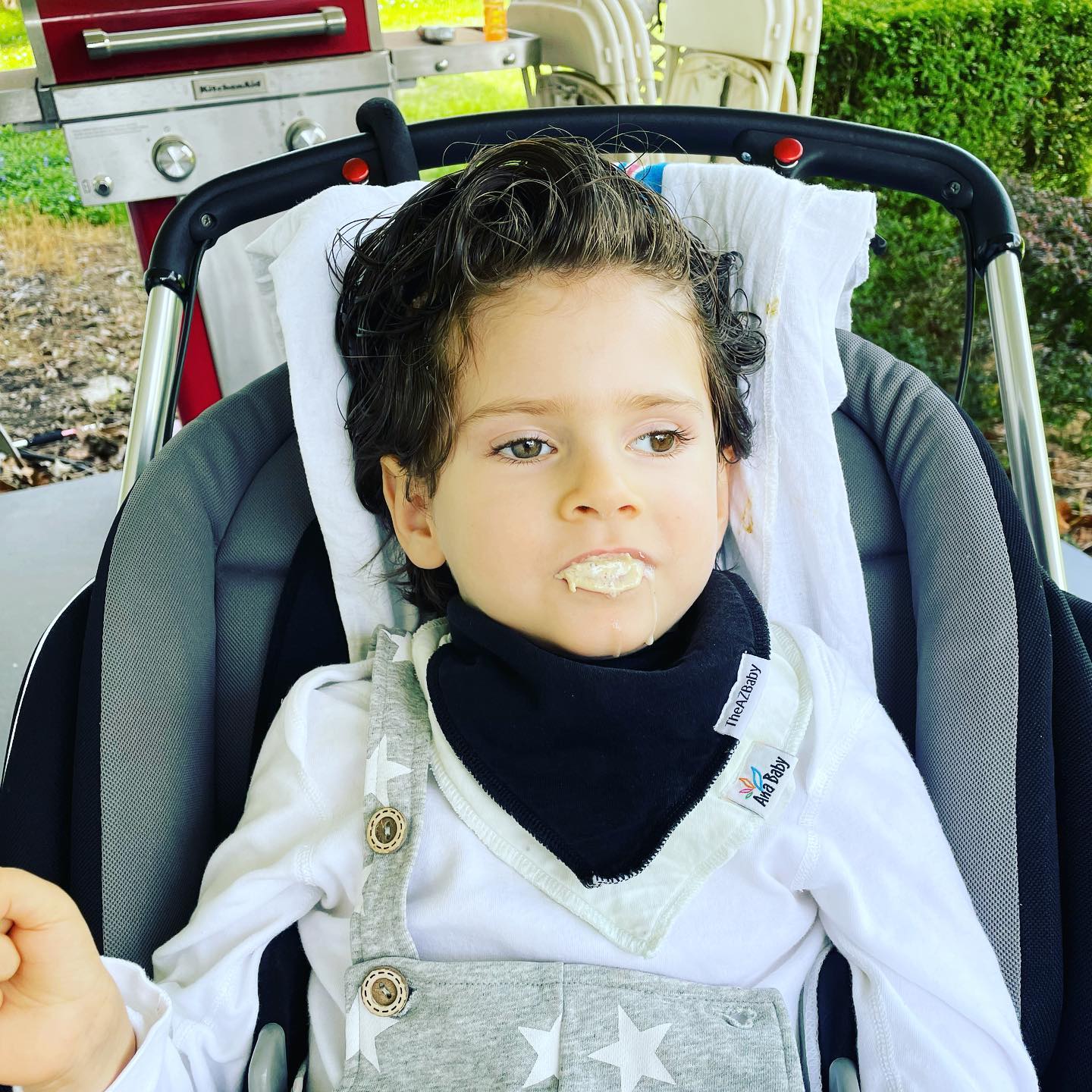 Benny is sitting outside in the Ohio sunshine enjoying dinner! Benny uses a G tube to meet his nutritional needs and eats small amounts for pleasure. Since we got home from the hospital, Ben has been signing “eat” more and more often! Benny’s enjoying some hummus from our dinner on our porch in Dayton. ... Here’s to more and more family dinners together. 💕 #savebennyandjosh #curecanavanfund #hope #miracles #cureraredisease #curecanavan