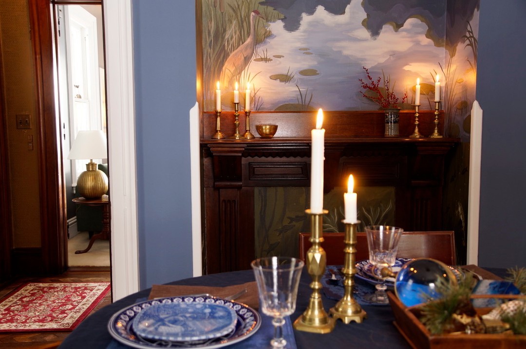 Our client who commissioned this piece is a collector of all thing interesting. They go thrifting and antiquing all across Wisconsin, so even while we were painting this piece they were dreaming of all the unique ways they could style the mantle and the table near by.
This is one of my favorite arrangements, with the blue and white plates and little oddities of the lake.
You get to decide how your space feels and the more elements of your personality you bring to it the more you will love it in the end.
