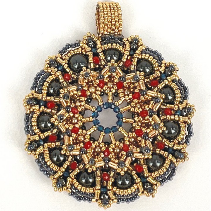 "Galapagos crab" Wreath Pendant. Inspired by the striking red crab resting on a volcanic rock in Galapagos, this unique handwoven pendant is just as striking with lots of depths, layers, sparkle and accents. Hematite colored pearls of several sizes, intricately woven into layers of seed and tube beads, with plenty of sparkle froma variety of Swarovski crystals. https://www.stelidesign.store
#oneofakind #@oneofakindjewerly #beadedjewerly #beadedpendant #pendant #handmade #handmadejewerly #@craftjewerly #pearls #swarovski