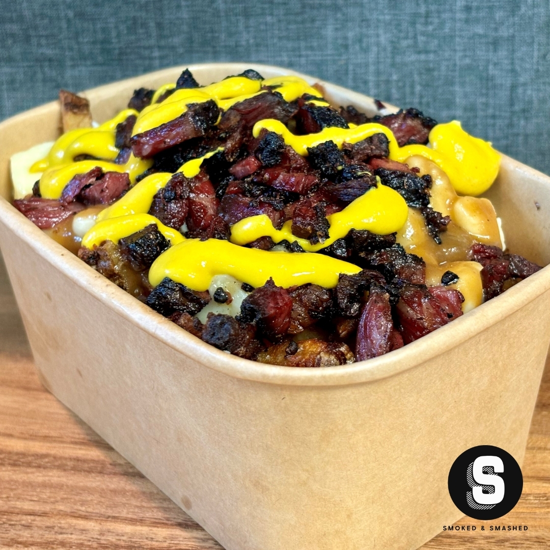 The Montreal Smoked Meat Poutine.
Double blanched russet potatoes, house made beef gravy and cheese curds, topped with a generous mound of our chopped Montreal Smoked Meat which we render down into lardons. The mustard adds a little bit of tanginess that compliments all the flavours. It's not just for show and if you're not feeling it; all good. Opt for it out.