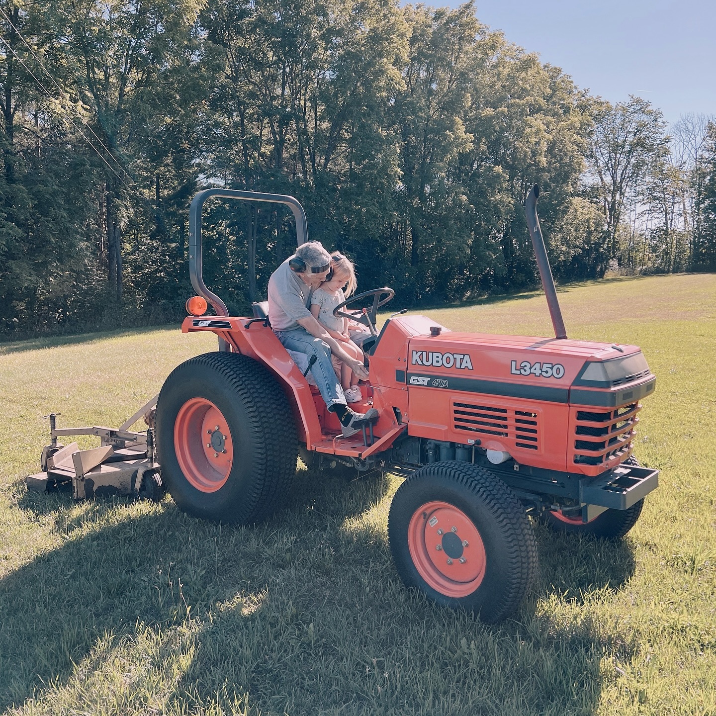 Helping honorary Grandpa with tractor chores. #homegrowntomatoes #daysinthecountry #daycaregrandpa #tractorlove #childcare #nanny #nannyshare #daycare #torontobeachesdaycare #homedaycare