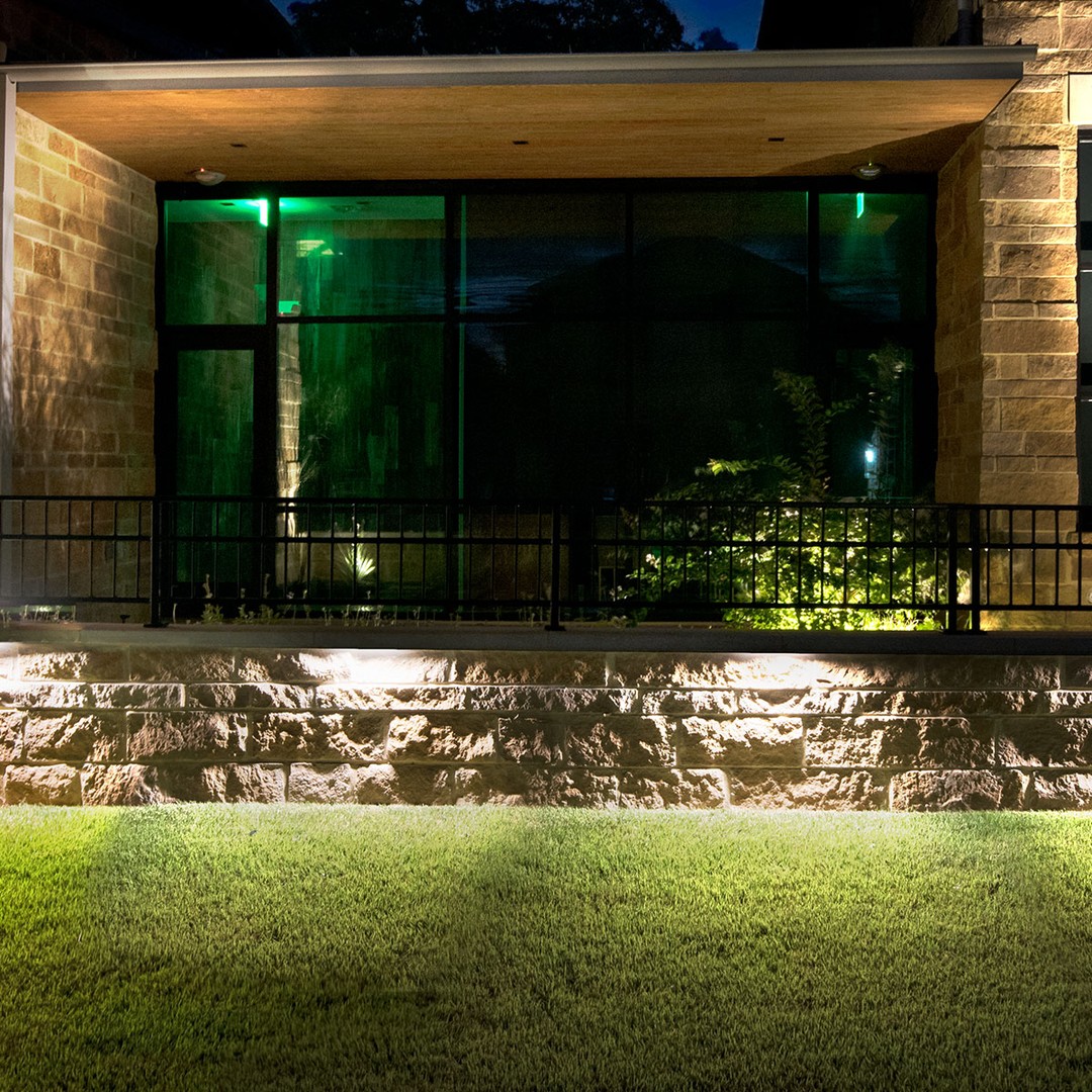 Hardscape Lighting gives this wall a beautiful aesthetic at night!