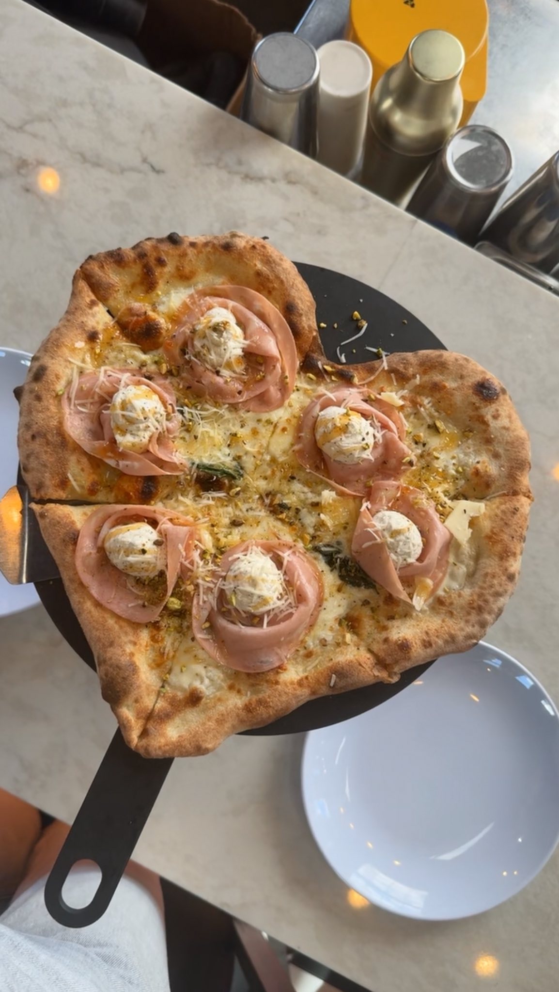 Love at first slice. ❤️🍕 Our heart-shaped white pizza is bringing the romance this Valentine’s Day weekend. It’s layered with fresh mozzarella, ricotta, mortadella, a sprinkle of pistachios, and a drizzle of hot honey for that perfect sweet heat.
Because nothing says be mine quite like pizza. 💕🍕 #slice #lovelove #valentinesday #nightout #pizzalover