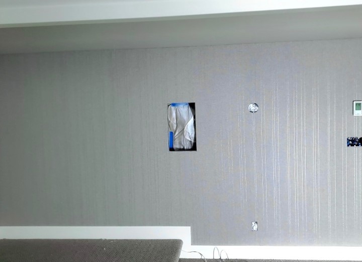 Another job well done by the team here at Mettes! The unassuming yet bold grey pallet of this wallpapers pattern modernizes the space while the subtle vertical line detail gives ‘height’ to the lower ceiling portion of the room.