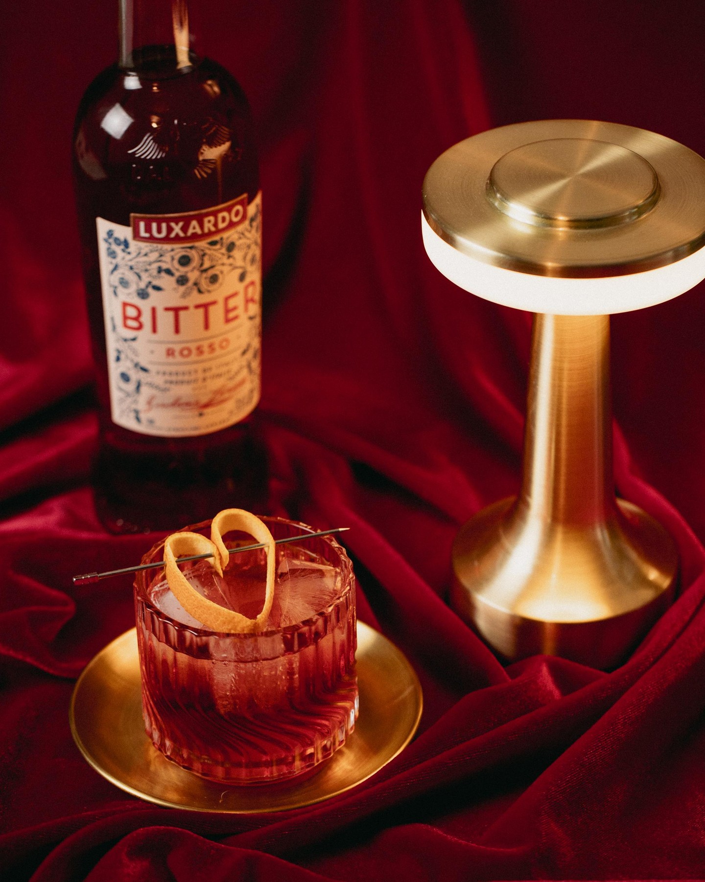 A classic Negroni with a little love. Made with Luxardo Bitter Rosso and garnished with a heart-shaped orange peel — bittersweet never looked so good.