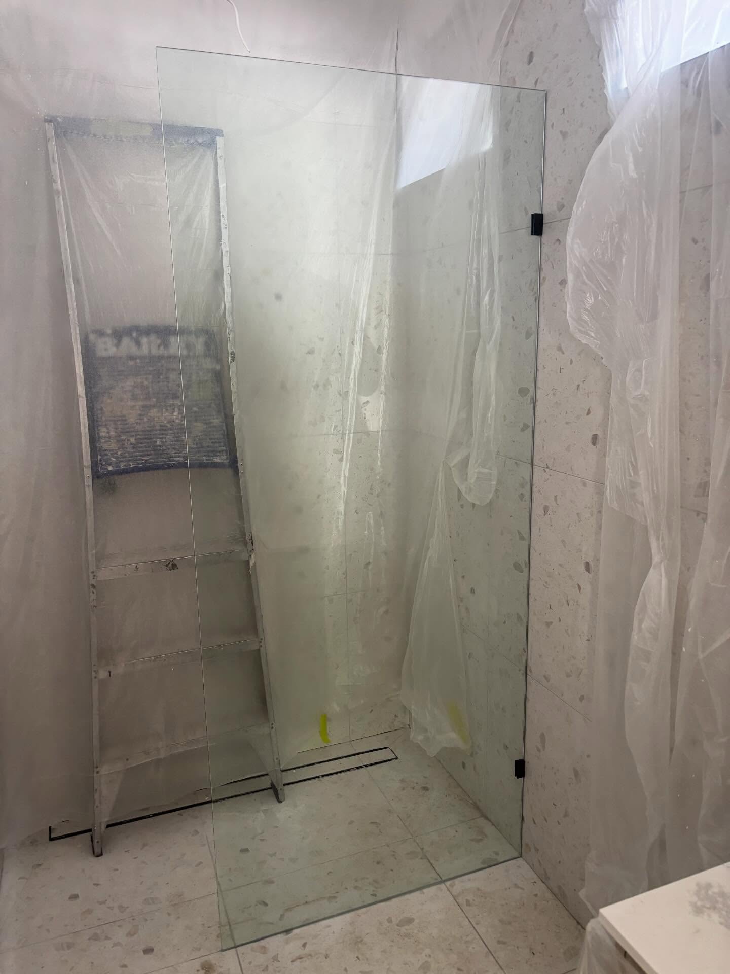 Two frameless fixed panels installed this morning in Seddon, using black brackets.