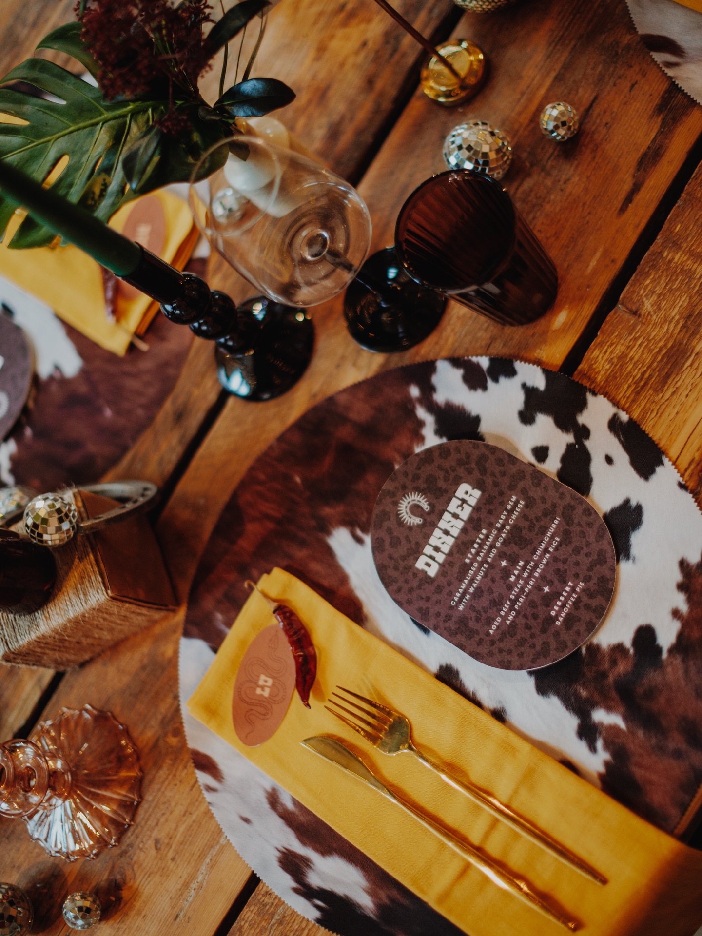 I CANNOT BELIEVE I’M ABOUT TO SAY THIS…
Cow print placemats.
Never once did I imagine using this print in a wedding design.
And yet?
It works.
Not because cow print is “trendy”.
But because everything around it was bold enough to carry it.
Sunshine yellow napkins.
Bubble glass candlesticks.
Deep green taper candles.
Rustic hay bales.
Vintage ink pot bud vases.
Metal horseshoes.
Even the florals were intentionally wild.
Movement. Texture. Leaves. Nothing too polished.
That’s the point.
When the design is cohesive, you can push boundaries.
You can take something unexpected and make it feel elevated.
So if you’re dreaming of a cowboy inspired wedding, we could take this direction, refine it, twist it and make it completely yours.
Or…
If you just love how fearless we are with tablescapes, you already know where the link is.
Models: Astrid (she/her) @astrid_hexe_ and Conor (he/him) @i_am_dreadvisage
Organised by @altweddingfair
Photo: @altweddingco
Venue: @shackrevolution
Styling: @untraditionalweddingstylists
Florals: @fleurandrebelle
Dress: @rebelrockbridalwear_
Suit: @bethwilsonembroidery
Hair & Makeup: @katiegale.bridal
Stationery: @with_bells_on_invites
Jewellery: @rockandrosejewellery
Banner: @taracollette
Music: @samjaynesings
#altwedding #nontraditionalwedding #cowboywedding #emowedding #weddingstylist