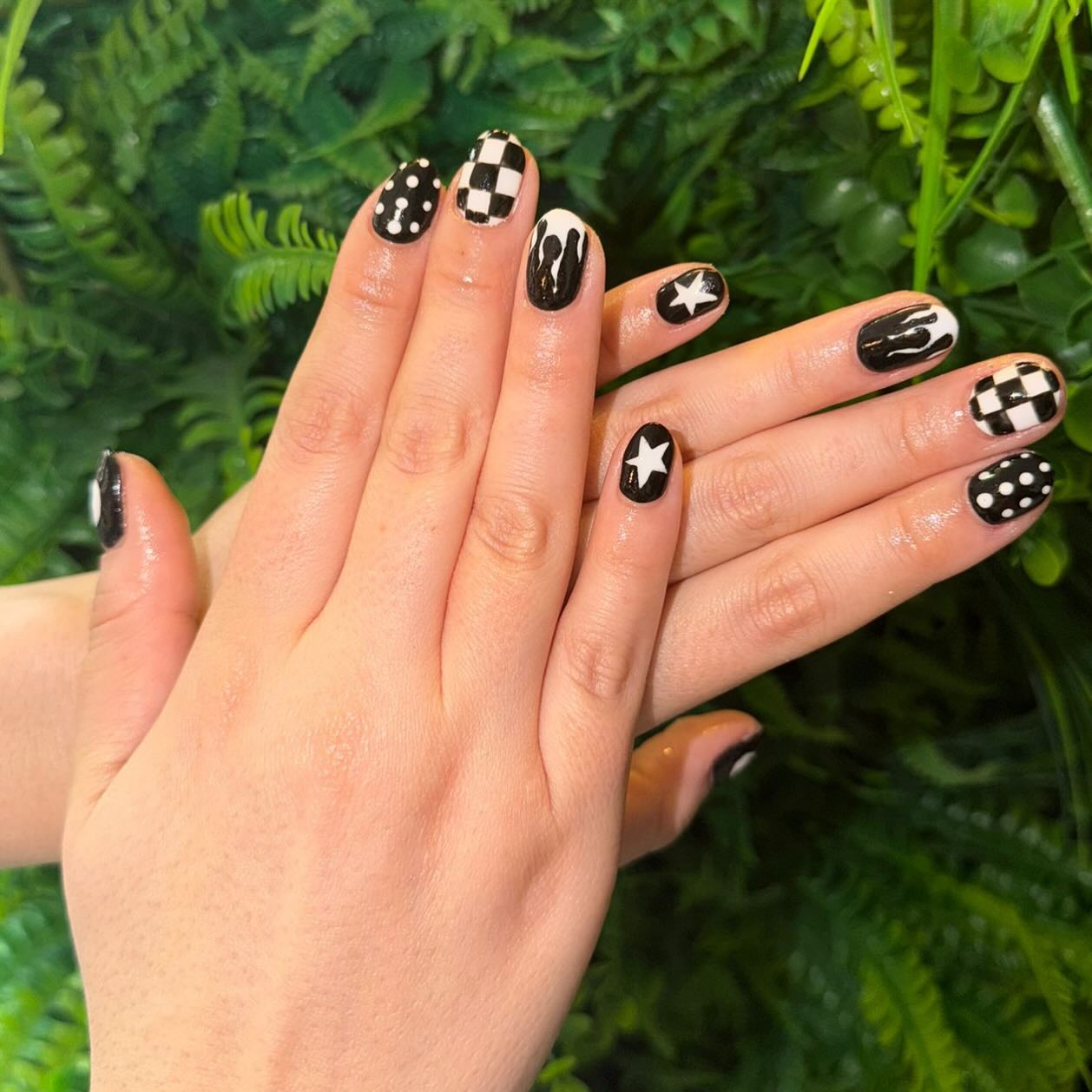 Black & white but make it bold. 🖤🤍
Fresh set by our senior beautician Jemma bringing all the cool, alternative vibes. Each nail has its own personality – from classic checkerboard and retro polka dots to dripping black tips and statement stars. A monochrome mix of glossy black and crisp white designs that feel edgy, playful, and a little bit rock ‘n’ roll.
If you can’t choose one design… why not wear them all? ✨