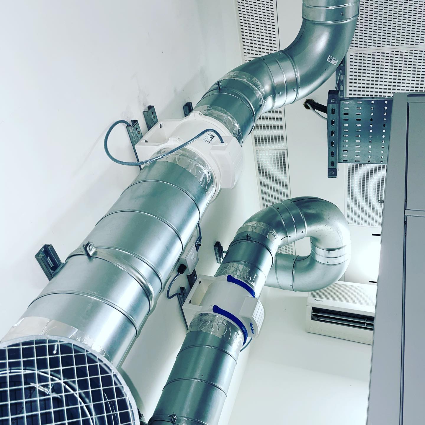 Air transfer fans complete with fire dampers & power supplies installed between two server rooms to aid with temperature consistency.
