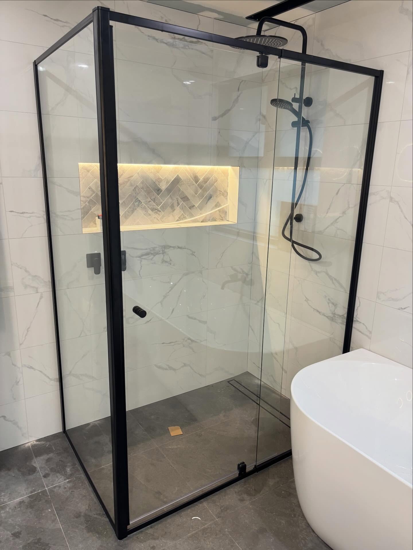 Immaculate black semi-framed shower screen as part of a bathroom renovation in Wandin!