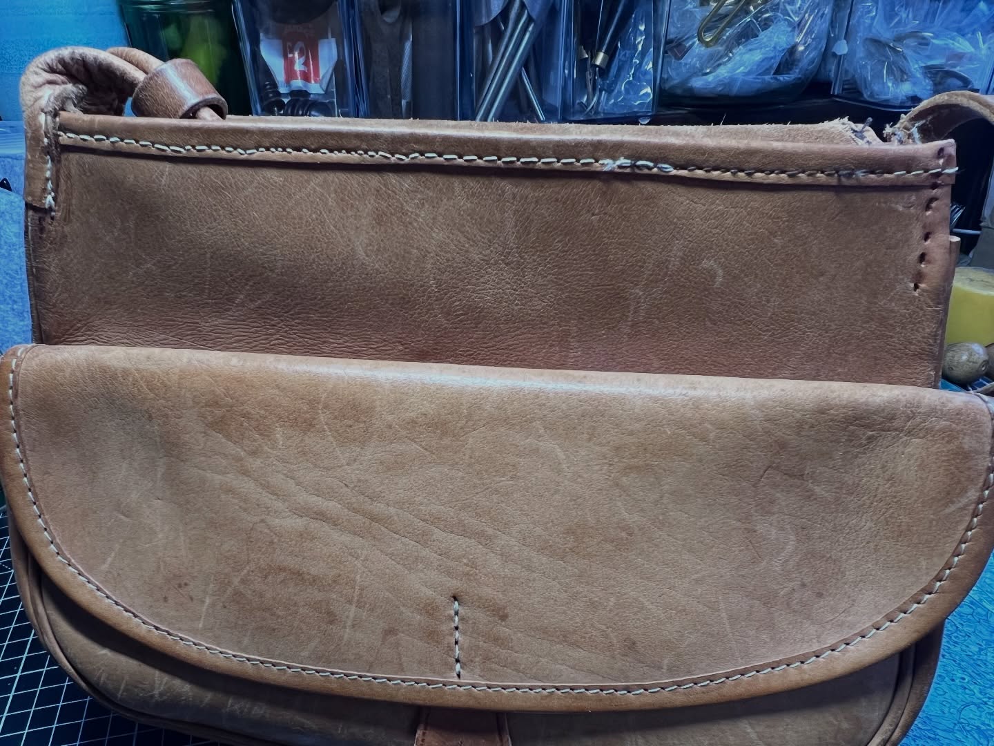 Recently had this beloved bag in which has travelled the world with a lovely lady. She’s taken it to a local cobblers and … well… yeah… made a right old cobble of it. Their machine stitches had perforated sections off it by piercing in between the existing holes, the wrong size and colour of thread and some sections were just bloody ugly! With a bit of care and precise hand stitching it’s back home to a very happy client who can take it on yet more adventures 💼 🌍 ✈️ Thank you for the chocolates and flowers it was very kind of you 🌷 #leatherbag #leatherrestoration #smallbusiness #carenotcuts