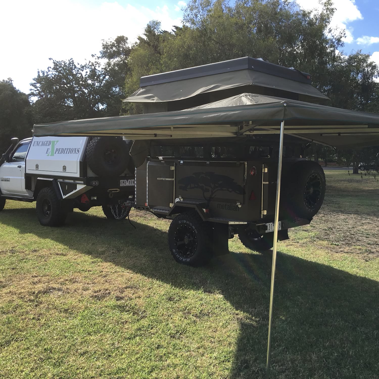 Ostrich awning and Bundutop electric roof top tent on Metallian maxi off road trailer by tough touring moorabbin - you can find us at www.toughtouring.com.au or phone 0477 002 932
