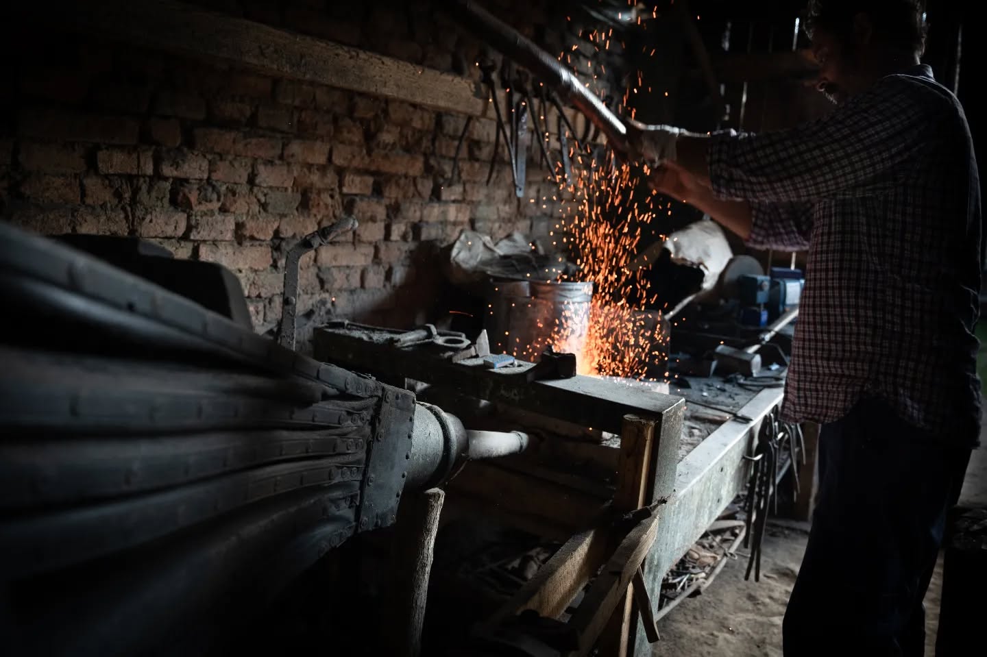 A metalsmith and his son. Also, one of their many dogs. Because dogs.
