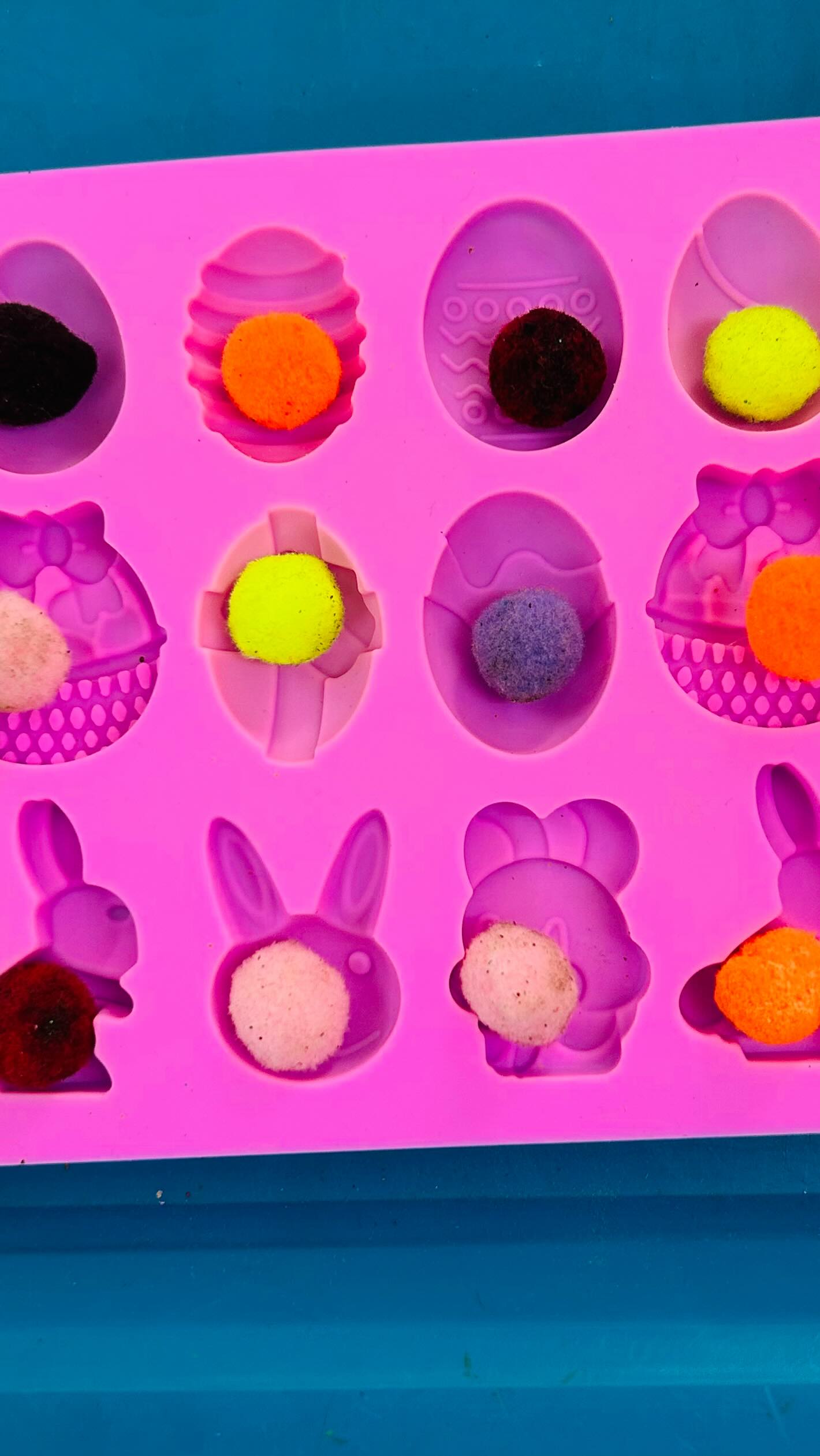 A sweet Easter practical life activity 🐇Little hands carefully placing colourful pom poms into chocolate moulds , building fine motor skills , concentration and hand-eye coordination in such a fun way !💜#montessoripreschool #toddler #preschool #education #easteractivity