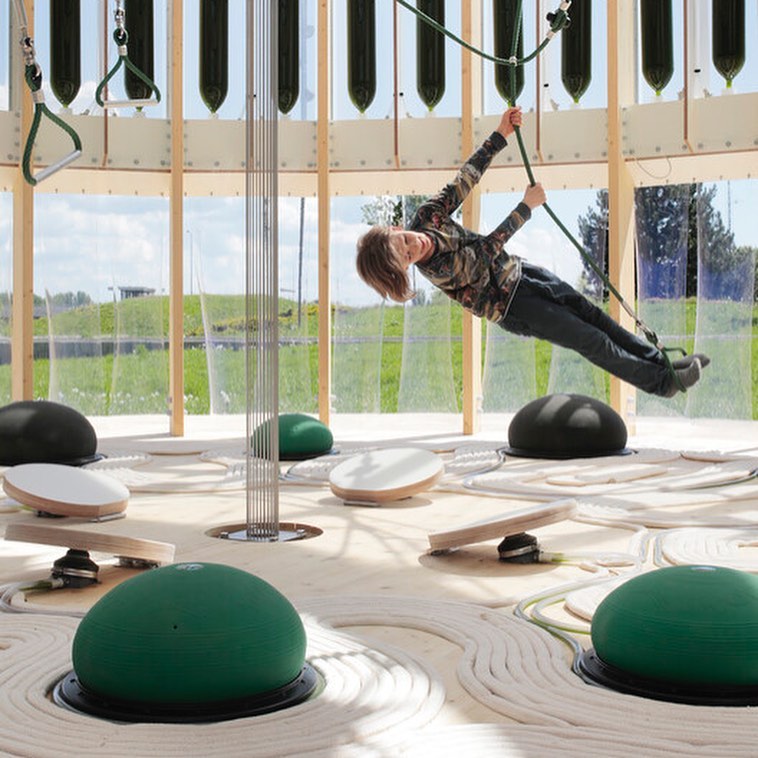 We love the idea of a play space that also helps purify air as has been designed by @ecologicstudio in Poland. The play space creates a microclimate for children using applied biotechnology to mitigate the effects of pollution on children’s health. The cylindrical timber structure is wrapped in an ETFE membrane protecting 52 glass algae reactors. The glass reactors contain 520 litres of living algae cultures that can filter a flow of polluted air of 200 litres/minute. While the liquid medium washes particles, the algae actively eat the polluting molecules as well as carbon dioxide to then release fresh clean oxygen. The filtration process is powered by solar energy, as well as the movement of children jumping on the foot pumps!
The peak reduction rate of pollution is an impressive 83% which is calculated using real-time data from pollution sensors. With air pollution categorised as one of the biggest global health threats according to the World Health Organisation (WHO), this playspace uniquely showcases how innovation and biotechnology can help mitigate the effects on health.
Project: AirBubble Playground
Designer: @ecologicstudio
Structural Engineer: YIP London
Photographs: Maja Wirkus
Location: Warsaw, Poland
.
.
.
#citiesforplay #playfulcity #childfriendlycity #play #learningthroughplay #urbandesign #placemaking #publicspace #urbanplanning #citymaking #urbanchildhoods #citylife #urbanista #planning #citylab #citiesforpeople #playmatters