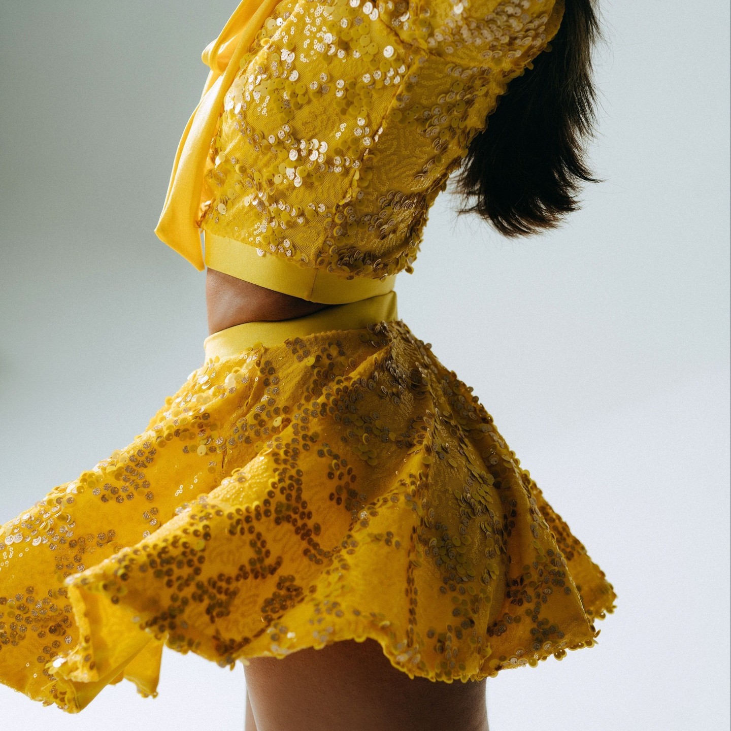 ✨ Shimmer in the spotlight with our dazzling "Elegant" yellow sequin collection that's all about spreading joy! ✨ This specialty sequin fabric can be transformed into any style you desire. Shown here in the "Trudy" Top + Circle Skirt #dancecostumes #dancer #costumes