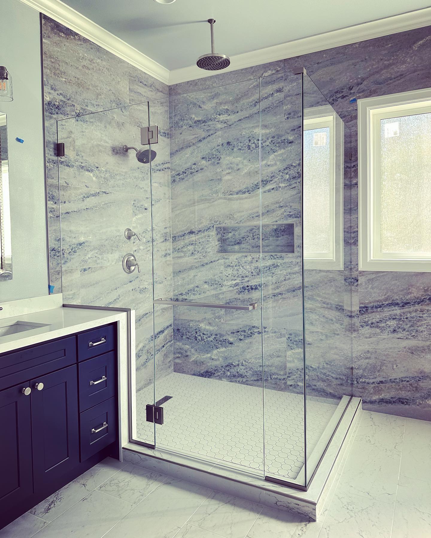 ULTRA-CLEAR LOW-IRON GLASS | brushed nickel finish + contemporary hardware
Starphire Ultra-Clear Glass has 87% less “green” than your average Clear Glass. With beautifully flat polished edge-work, this shower glass glows blue on its corners and shines like a jewel. Here, Starphire’s unmatched color fidelity allows the colors of the tile to remain crisp and consistent from wall to wall. Ultra-Clear also provides 91% Visible Light Transmittance, ensuring natural light passes freely through the enclosure to brighten the entire en suite.
Hardware by @crlaurence (Geneva Series Bracket, Square Clamps, Vienna Series Hinges, 24” “SQ” Towel Bar with contemporary Square knob on interior strike for user centricity.
Starphire Ultra-Clear Glass by @vitro_glazings, Fabricated by Tacoma Glass Manufacturing of Frederickson, WA.
Like all of our shower enclosures, this project was factory-coated with @enduroshield for years of easy maintenance.
#shower #showerdoors #showerdoor #showerdoordesign #showerdesign #showerglass #showerenclosure #showerenclosures #glassshowerdoors #glassshowerdoor #frameless #framelessshowerdoor #framelessshower #glass #heavyglass #lowiron #starphire #starphireglass #enduroshield #enduroshieldglassprotection #bellevue #425
