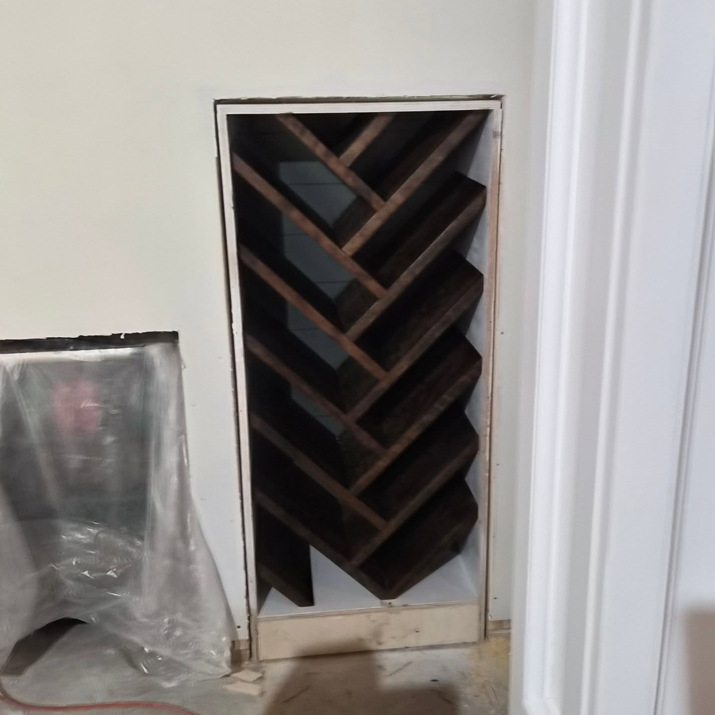 We love both creative and technical challenges. This wine rack certainly provided ample amounts of both. The back wall is nickel gap, painted to match an accent wall in the room and the rack is made of 5/4×14" Cherry stained in walnut to match the floors. One step closer to realizing this incredibly basement project.