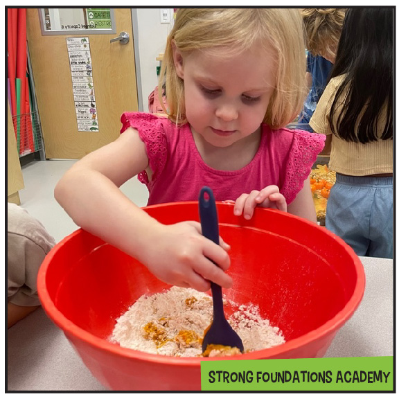 We LOVE cooking in the classroom! Our PreK kiddos had a blast making pumpkin cloud dough — and while it was tons of fun, it was also full of learning! Students practiced reading and following a recipe step by step, identifying ingredients, and measuring carefully. We talked about concepts like more, less, full, and empty while strengthening our early math skills in a hands-on, meaningful way.
Cooking in the classroom builds so much more than just tasty creations. It encourages teamwork, listening skills, vocabulary development, fine motor strength, and confidence. When students see ingredients transform right before their eyes, it sparks curiosity and excitement for learning!
At Strong Foundations, we believe some of the best learning happens when children are actively engaged, exploring, and creating. Visit StrongFoundationsAZ.com to take a virtual tour, schedule an in-person tour, or learn more about our school. To inquire about enrollment, please call (480) 738-3346 or visit www.StrongFoundationsAZ.com
#PreKFun #BestofChandler #ChandlerMoms #GilbertMoms #EastValleyMoms #ChandlerAz #AzKids #StrongFoundationsAcademy #ChandlerKids #GilbertKids #ArizonaKids