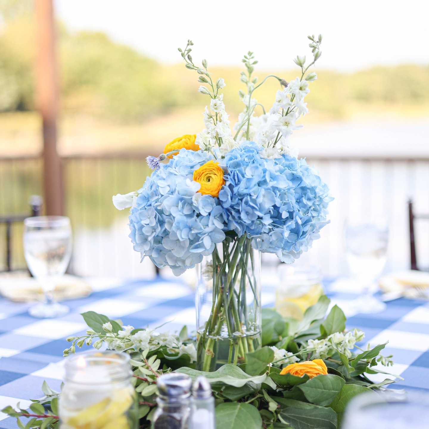 Blue hydrangea, yellow ranunculus, white delphinium
Greenery: Salal, Myrtle