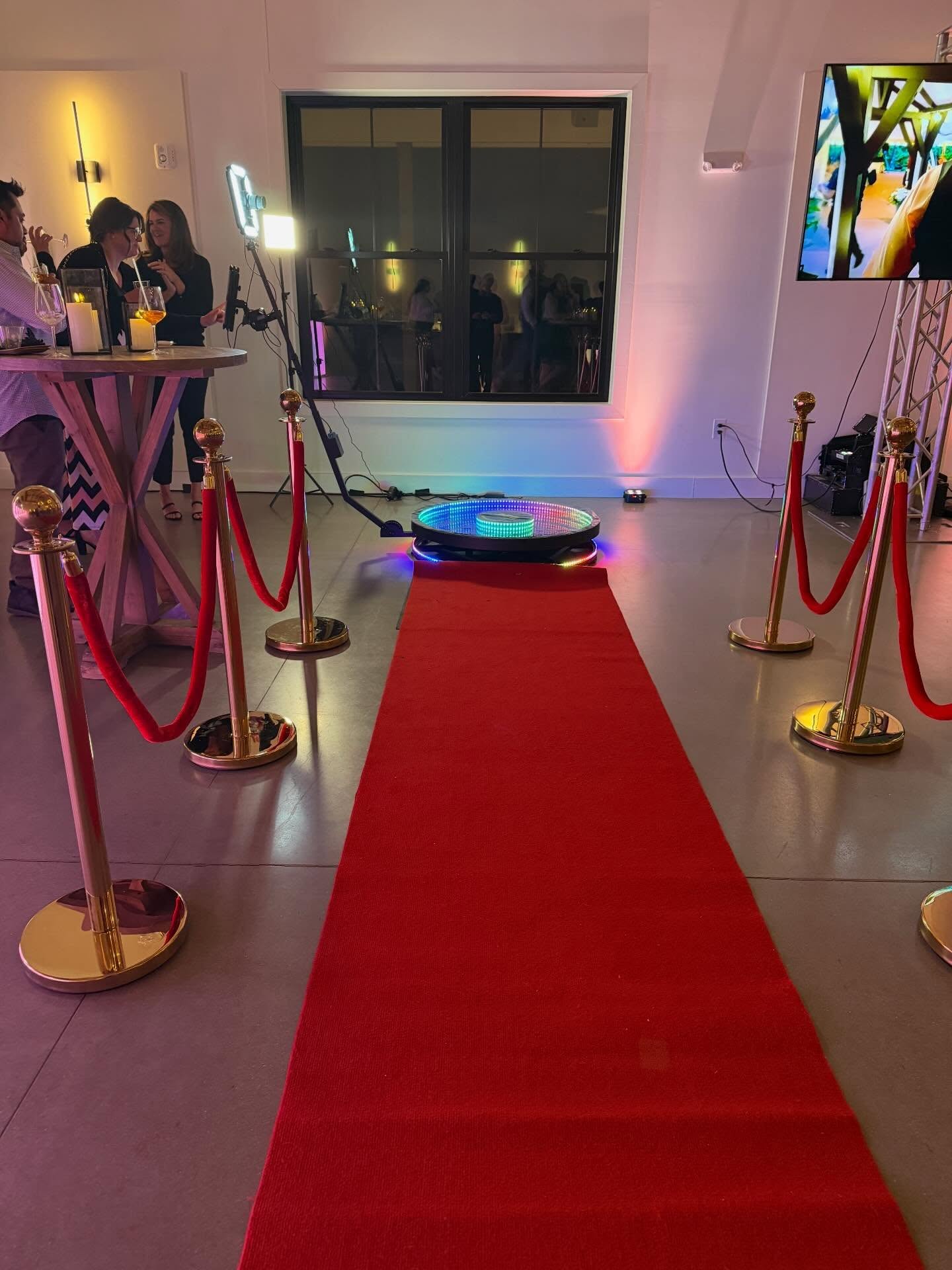 360 Photo Booth. In full effect with red carpet with gold stanchions.