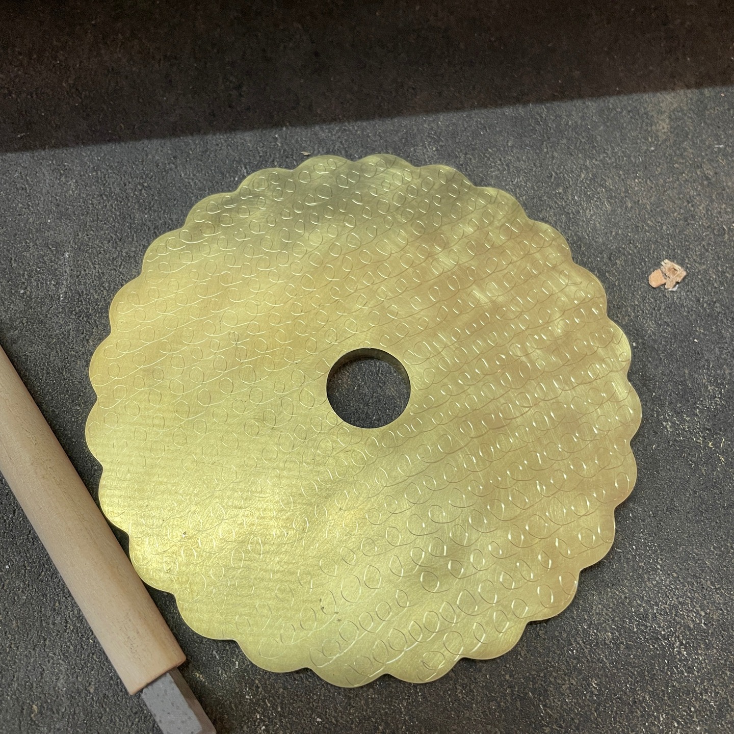 A rosette for a rose engine is a shaped cam or disc mounted on the lathe spindle that dictates the movement of the headstock, allowing for the creation of intricate, repetitive, flower-like (rose) or geometric patterns. We have recently been making our own rosettes on our rose engine lathe. We purchased .250" brass sheet from Metals "R" Us in 5"x 5" pieces. Our lathe can be computer controlled so by writing a gcode program we can create and cut rosettes. Once the gcode is written it is first tested on a tympan paper chuck as a pencil/pen drawing. Once I have the desired result the first rosette is cut using acrylic sheet and eventually some are cut using .250 brass sheet. The brass ones then have curling applied, curling was developed hundreds of years ago to decorate brass parts to reduce the visual signs of wear and tear. I followed an article by @Frank.Dorion to achieve this. I used powdered pumice stone with water and a cork followed by a swirling pattern using slate in a dowel to make a pencil. The brass sheet is prepped using the bandsaw and metal machinist lathe then over to the rose engine lathe. For those that have read this far and are interested I will explain the rubbing mechanism in a following post.
#roseenginelathe #ornamentalturning #complexturning #metalsrus