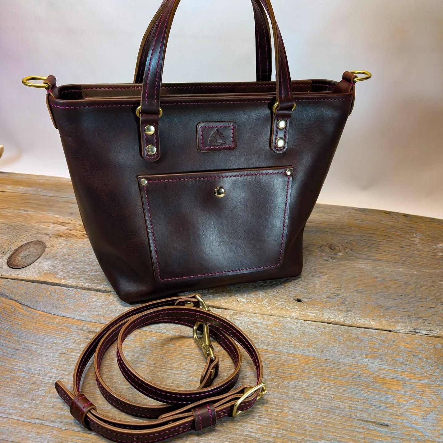 A Lawrie tote with a few modifications, zippered top, short fold down handles, crossbody strap, feet, and zippered hang pockets.