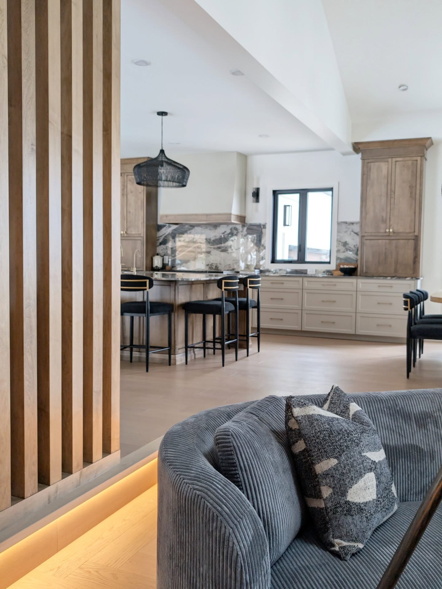 Open concept sounds effortless… until everything starts to feel like one big undefined room.
Taking down a load-bearing wall is an involved process but what you do after is where the design really earns its keep.
In this space, the goal wasn’t just openness, it was intention.
This custom divider wall subtly defines the transition from the conversation area to the family room while still allowing natural light to flow freely between the spaces.
A well-designed space needs purpose, proportion, and a bit of strategy.
Warmth isn’t lost in open spaces… it’s designed into them.
GC: @spruceside_construction