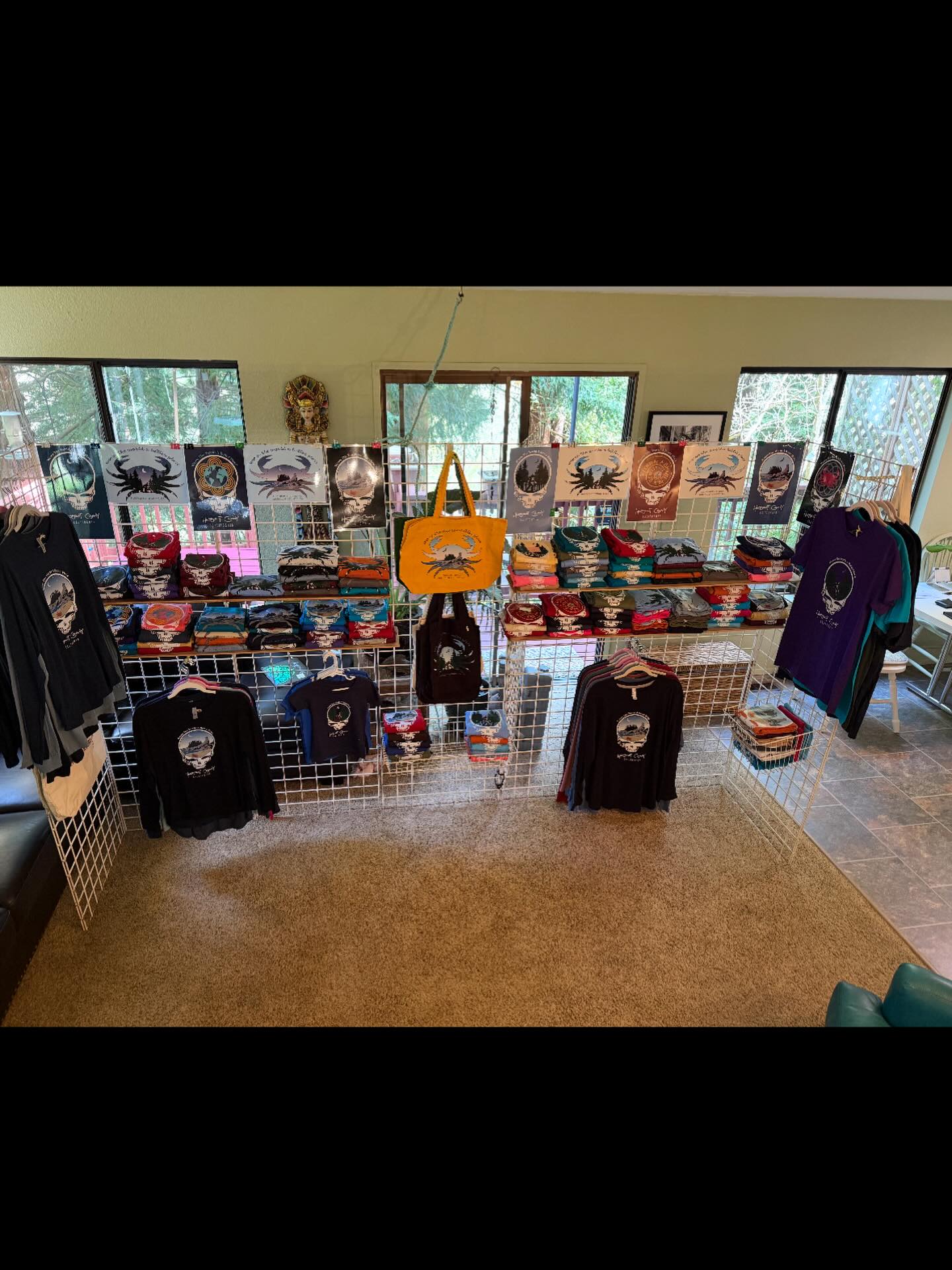 This week’s fun….Living room Mock-Up! We set up half our fair booth in the living room to work out the most inviting way to display our new line of Grateful Dead and Hero the Crab T-shirts at future fairs..