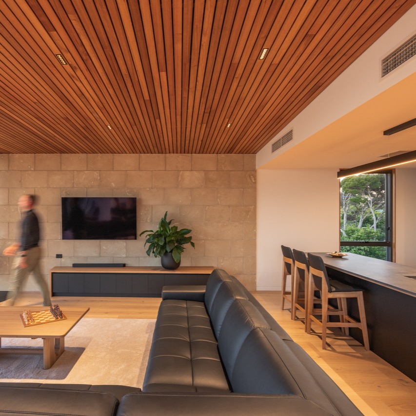 Tasmanian Coastal Home by Starbox Architecture. Wrapped in our Australian Oyster Limestone Traditional Blocks
Completed on a true beachside site, this home takes cues from coastal site in which it sits - simple clean lines, durable finishes, and a calm material palette that let the views do the heavy lifting.
The concept was all about form following view: the building is shaped to capture the primary outlooks of the ocean while still pulling in secondary water glimpses as you move through the plan.
From the street, the home is intentionally quiet and plain—a restrained, almost blank facade that turns your attention inward, then outward to the horizon once inside. The internal spaces then flow seamlessly from a cascading timber deck into a private, sheltered courtyard—a protected outdoor space designed for total relaxation which includes a multi person sauna, stainless steel hot tub, outdoor kitchen and fire pit.
External materials were selected for coastal character and durability:
• Oyster limestone (Limestone Australia)
• Scyon Linea™ weatherboards
• Powder-coated aluminium battens
• Cemintel Surround
• Pacific teak timber
Inside, the experience is anchored by a double-storey, light-filled atrium, drawing daylight deep into the centre of the home and reducing reliance on artificial lighting. A palette of warm, durable finishes—including oyster limestone and Tasmanian Oak—supports a layout focused on ease of movement and layered privacy.
Architect: @starbox_architecture
Photography: @nativedesignagency