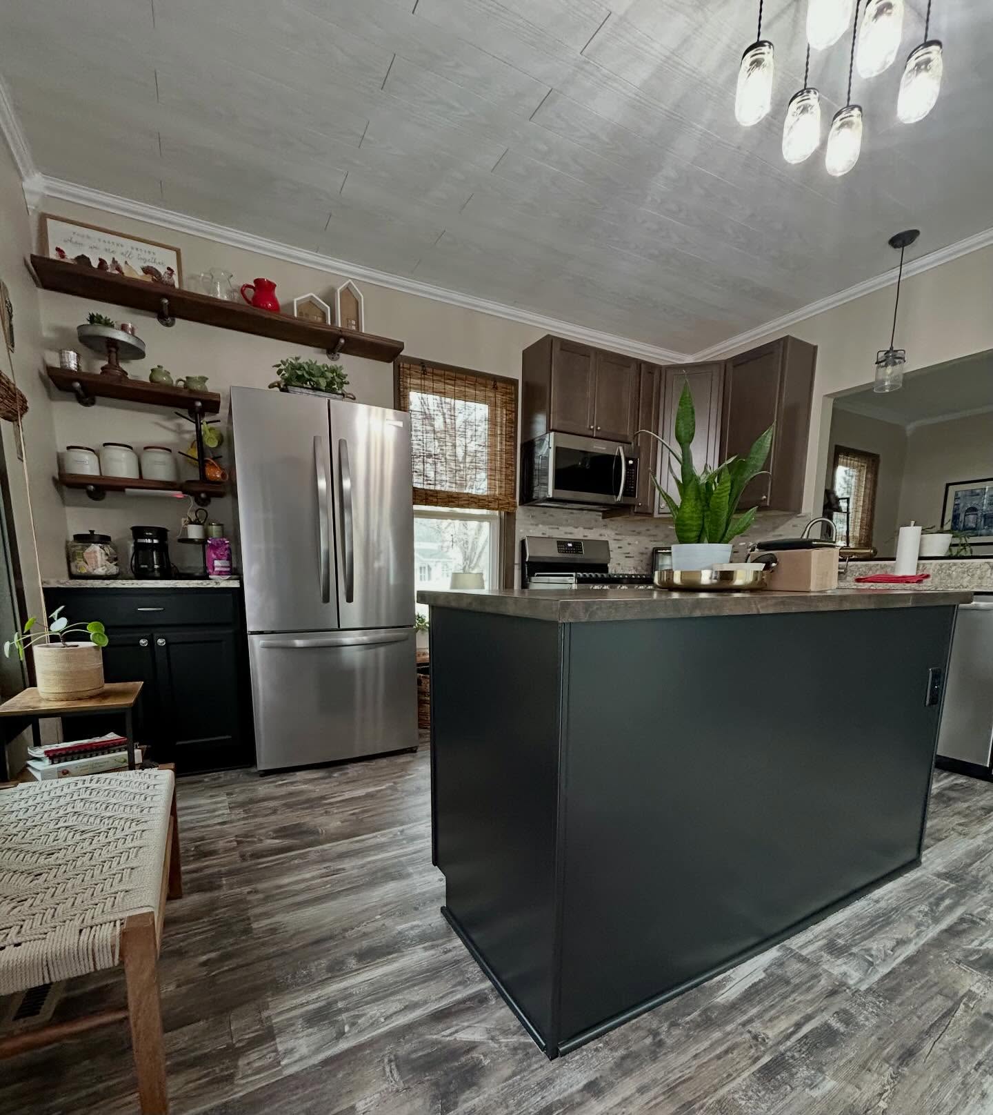 Striking Contrast: The Tricorn Black Transformation
There is something incredibly sophisticated about a two-tone kitchen, and this latest project is the perfect example. We just wrapped up the lower cabinets and island in Sherwin-Williams Tricorn Black, and the result is nothing short of stunning.
By anchoring the space with such a deep, saturated black on the bottom and keeping the original dark wood on the uppers, the kitchen feels grounded yet modern. The contrast brings out the rich grain of the wood while giving the entire room a high-end, custom-tailored look.
Why we love this look:
• Depth: Tricorn Black is a “true black,” meaning it doesn’t have distracting undertones, making it the perfect partner for natural wood.
• Balance: The dark-on-dark palette creates a cozy, moody atmosphere without losing the warmth of the cabinetry.
• Durability: A professional enamel finish on these high-traffic lower units ensures this bold look stays crisp for years to come. #hendersonhomepainting #twotonedcabinets #proffessionalpaintingservices #elkriver #elkrivermn