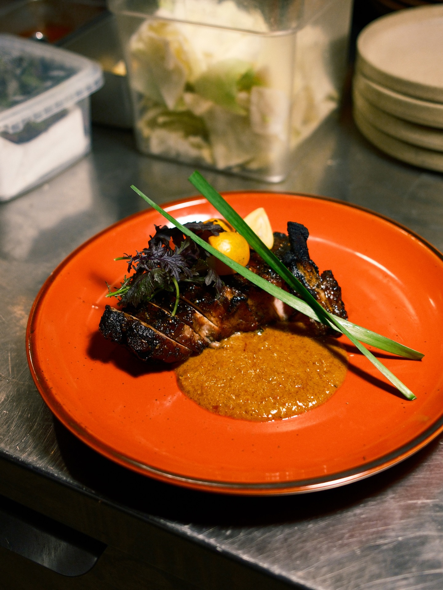 A dish we’re proud of
Charsiu pork chop, maple syrup glaze, sour curry sauce, house spice, purple mizuna and kumquat