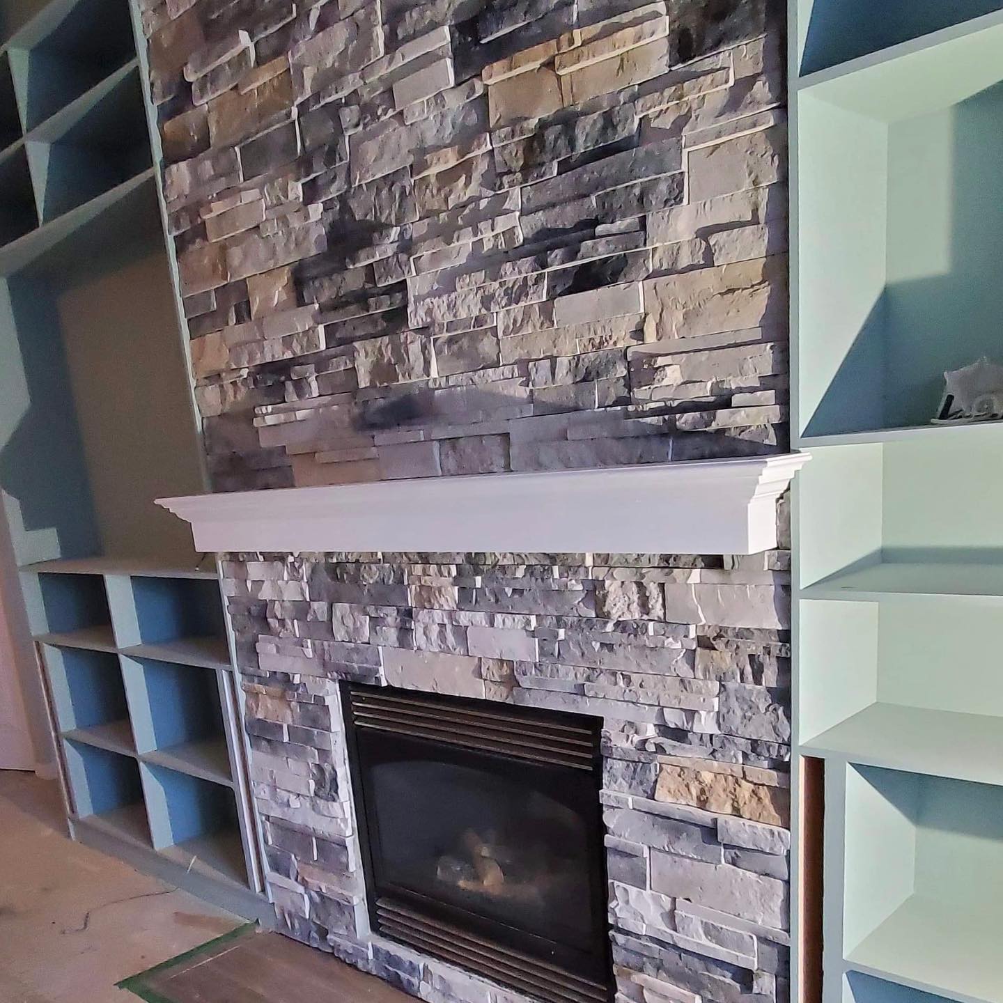 Check out the process pictures of this mantle. We first installed it to see what it looks like and the client asked us to cut the bottom off. Mitch had to fill the bottom in and repaint then re-install; this is the final product. π Swipe right to see more images.