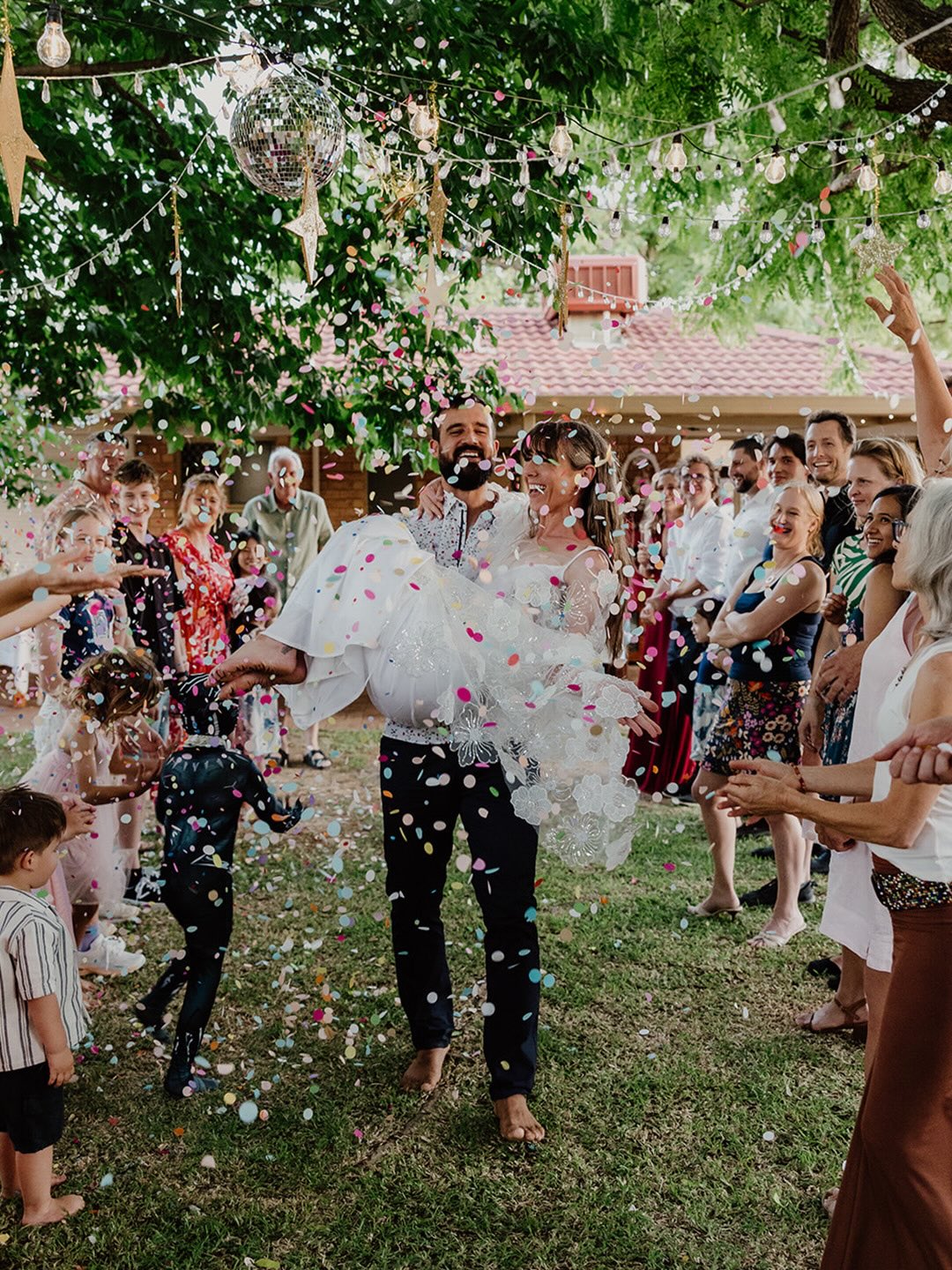 After keeping their elopement super small and chill (legals + gelato with the family) these guys threw a kid friendly New Years Eve AND wedding celebration party in their backyard, with all the confetti! Plus a bonus special appearance from Black Panther lol 😂