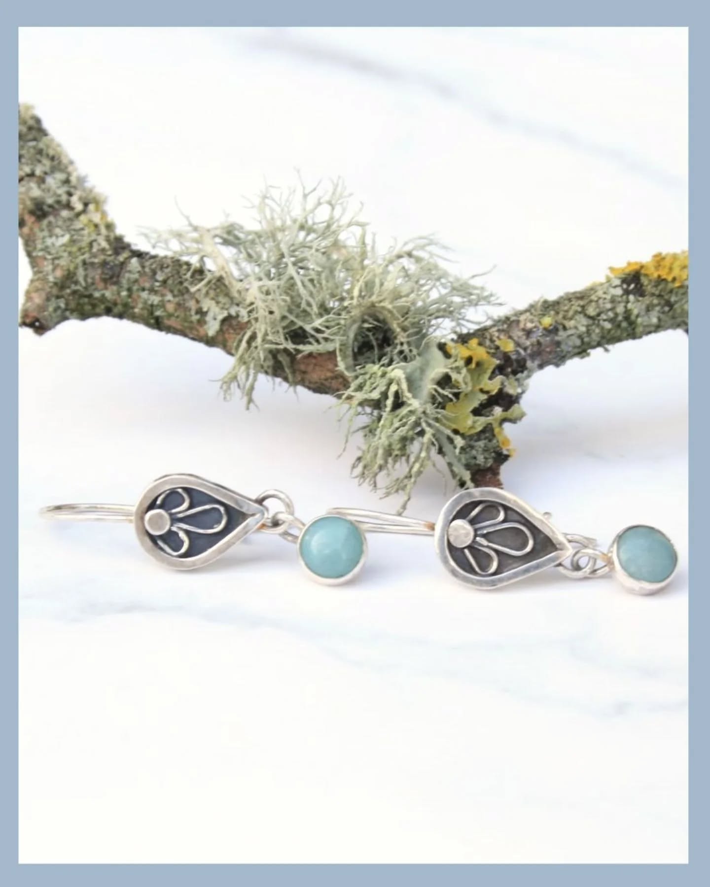 I've been working on a few new styles of earrings over the last couple of weeks. These ones feature a teardrop shaped shadow-box with a little silver flower inside. From the base hangs an amazonite gemstone which can move gently when worn.
I've always been drawn to this shadow-box style so look out for a few more pieces coming soon.
These amazonite earrings are available now and please get in touch if you have any questions.