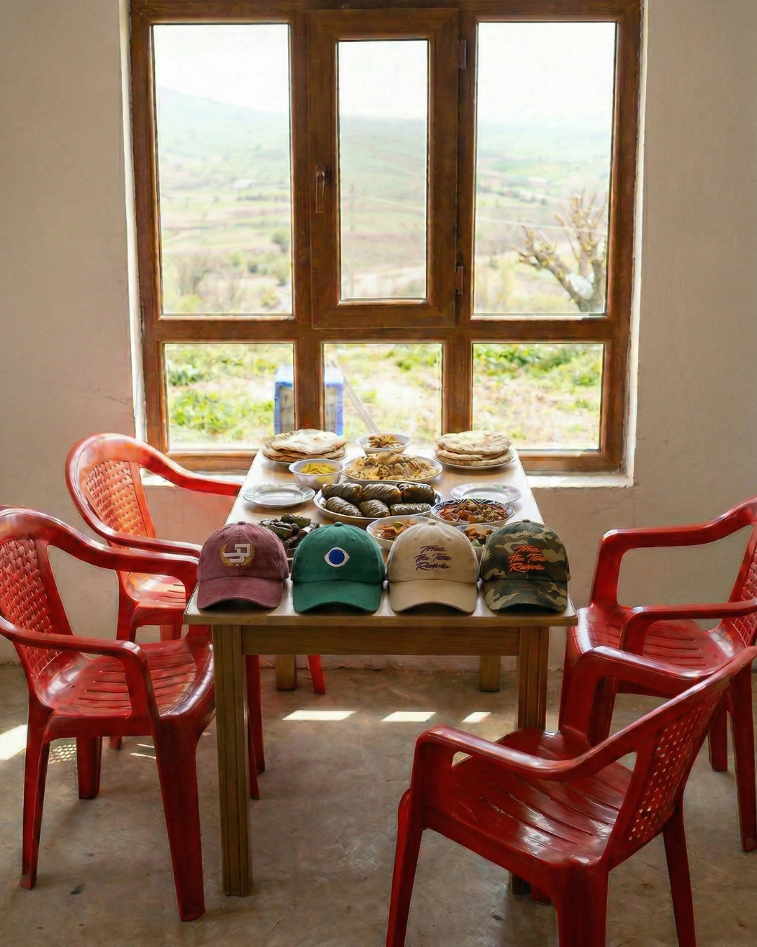 Part 3 of my concept release. AI helped me revisit my roots, not create imaginary worlds.
This window and scenery are inspired by a photo I took years ago in Nahla. Beautiful views of Assyria, a kitchen table full of food, but empty chairs - a space for the diaspora to return home. Our people and land are waiting.
New drop is still trending online. Orders will begin shipping this weekend 🙏🏽. Don’t miss out.