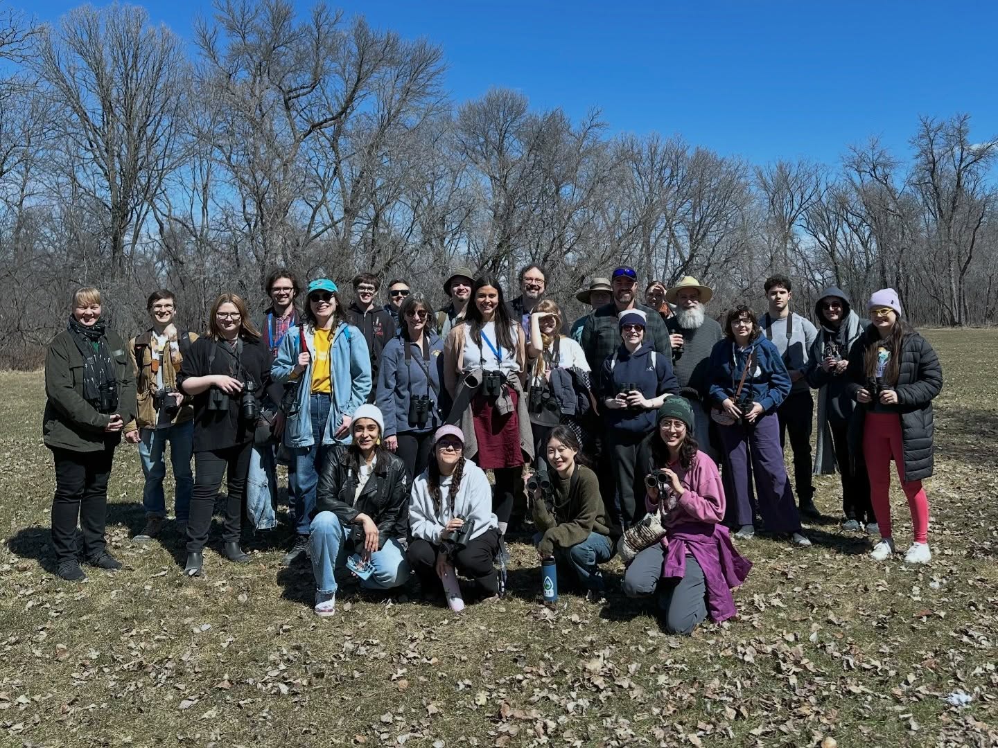 We are UMIBC birders and we believe birding is for everyone! We took on the sunshine today and had an absolute blast at King’s Park spotting 33 species!!!!! There were so many amazing bird joy moments! Some highlights included a majestic and huge Great Blue Heron, three Broad-winged Hawks soaring above us, a raft of Pelicans calmly surfing through the air, to fleeting glimpses at Golden-crowned and Ruby-crowned Kinglets (and so much more)!
Maarsii (thank you) to birders that joined us for the first time. And, thank you to the birders who come to every walk. Each and every one of you makes our walks together amazing.
Slide 1. UMIBC birders posing for a group photo.
Slide 2. Great Blue Heron.
Slide 3. Red-breasted Nuthatch.
Slide 4. Red-breasted Nuthatch digging out a tree cavity.
Slide 5. UMIBC birders walking to King’s Park.
Slide 6. American White Pelicans.
Slide 7. American Robin.
Slide 8. Yellow-rumped Warbler