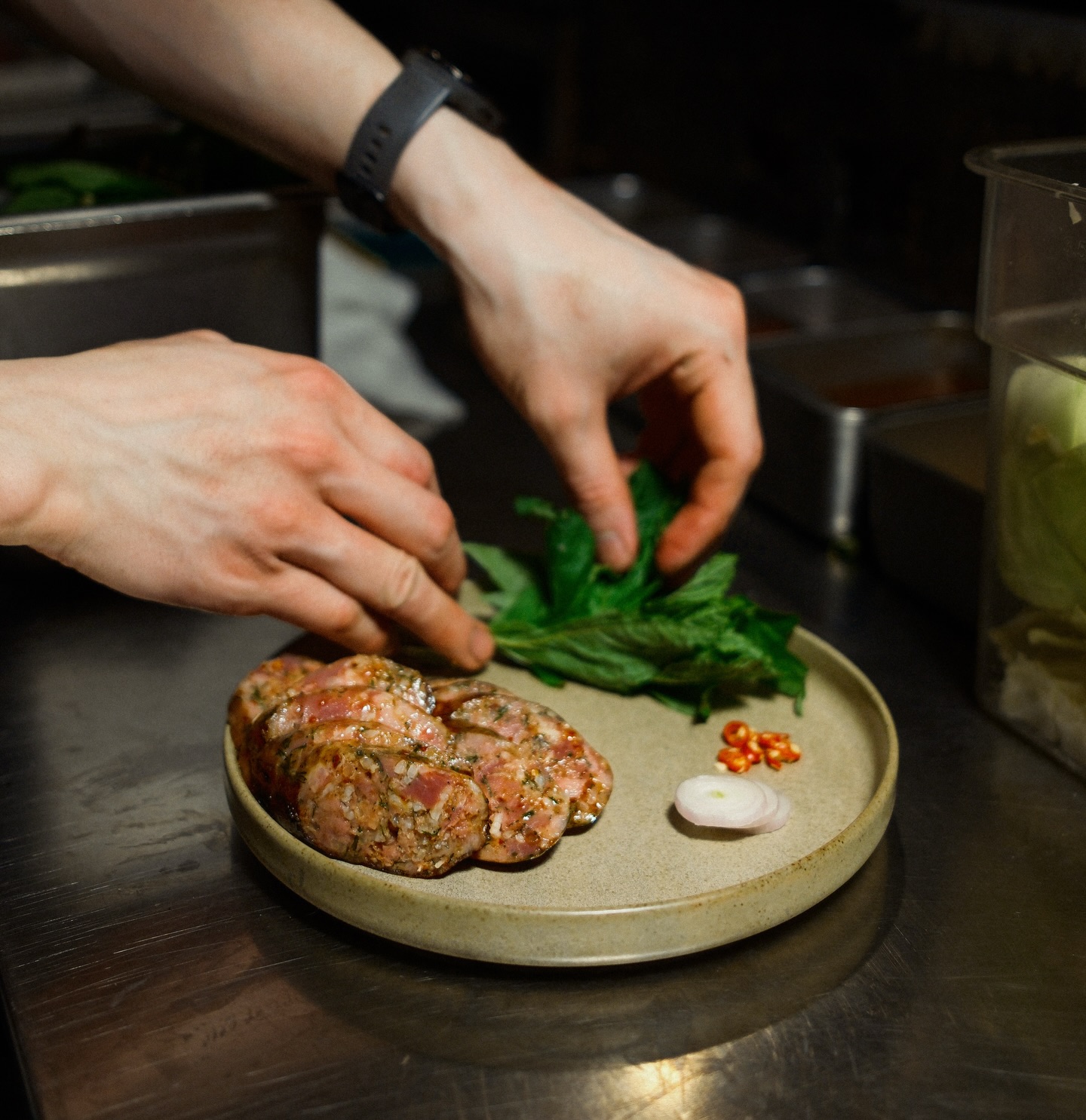 Our house-made duck sausage draws inspiration from Issan and Laotian sausages of Northeastern Thailand. Made with coconut rum, dill, and sticky rice, then served with fresh herbs, shallots, and bird’s eye chili 🌶️